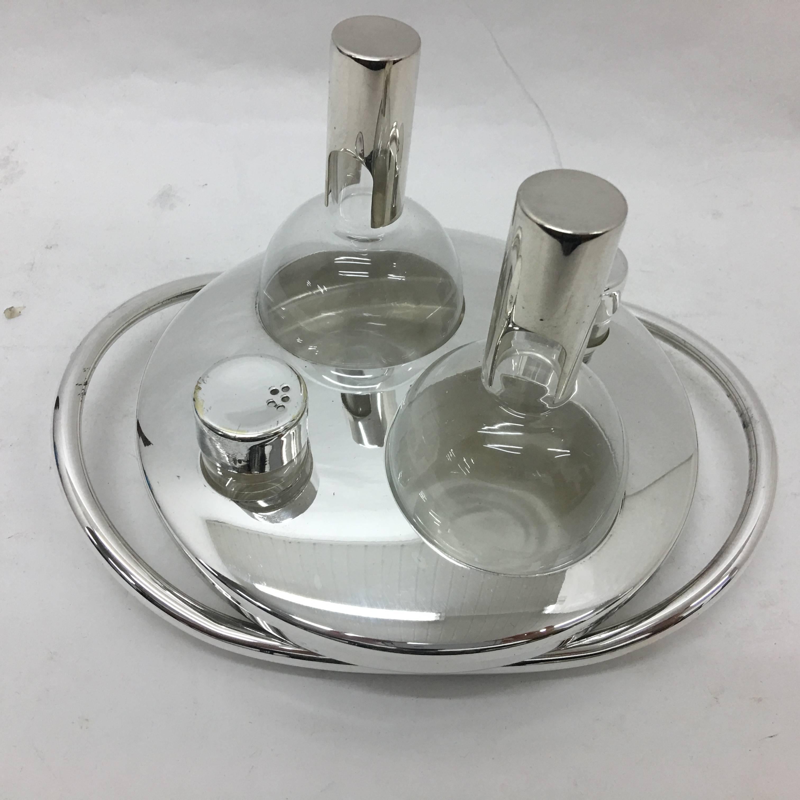 Silver plated cruet designed by Lino Sabattini, glasses are in perfect conditions, item has been replated. Marked on the bottom Sabattini, made in Italy.