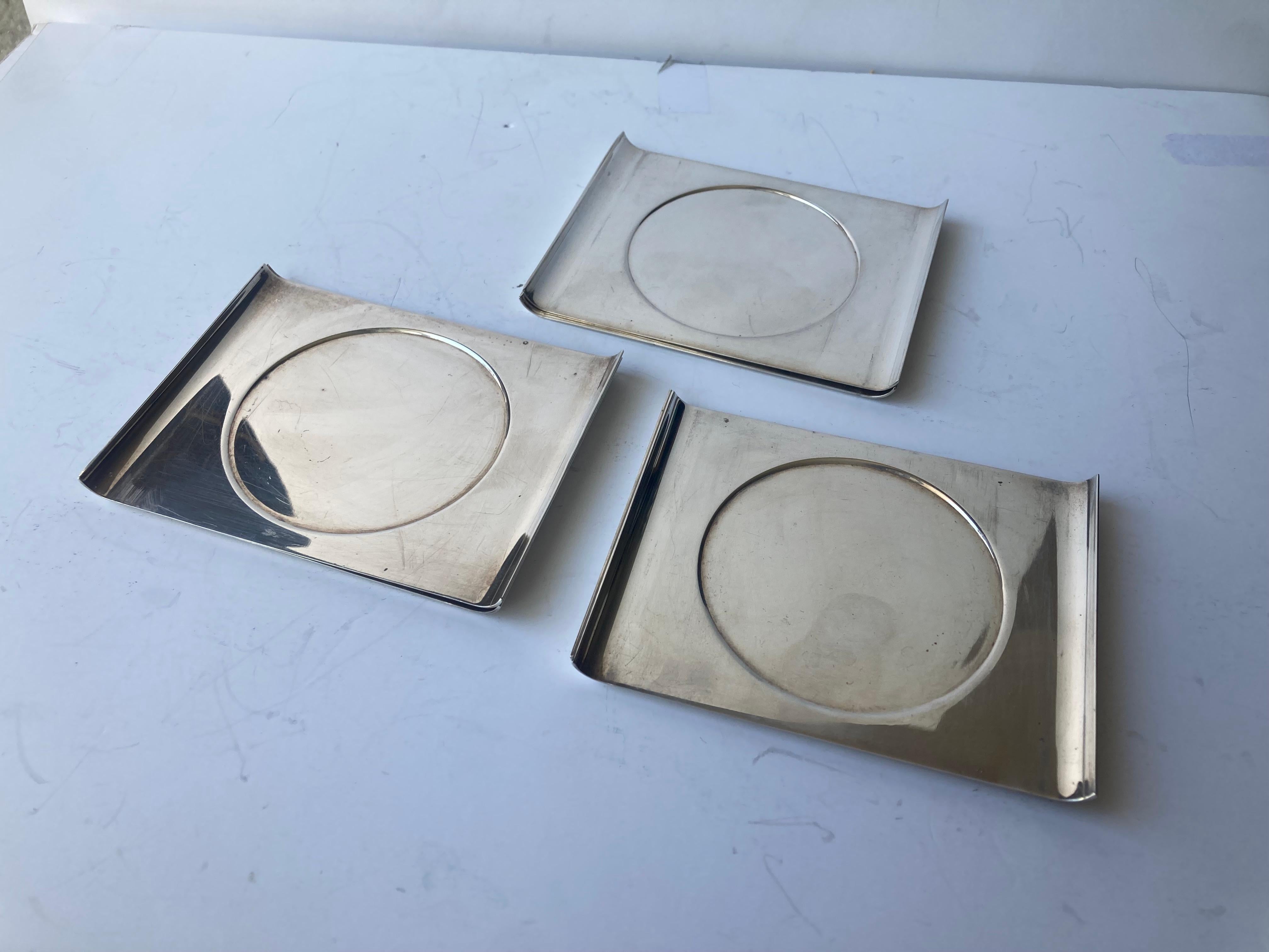 Jolie collection de six sous-verres Sabattini en acier inoxydable. Toutes les pièces sont marquées du poinçon standard Sabattini.