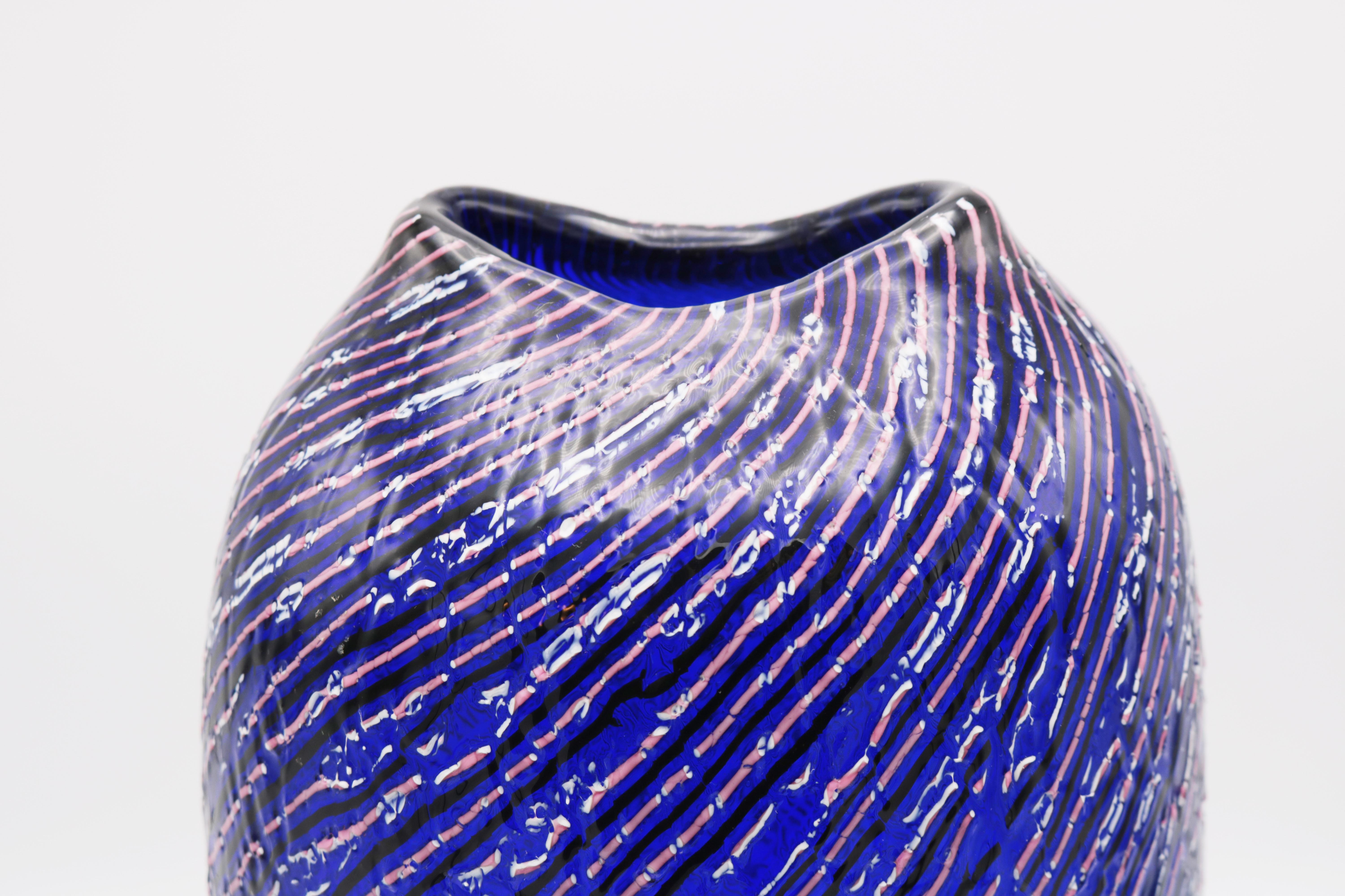 Lino Tagliapietra designed Italian art glass vase for Effetre International. Cased glass, clear and blue, fused ribbon, deep purple and pink/white. Craquelure. Marked: Effetre International Murano 1992 (engraved). Cased glass, clear and blue, fused