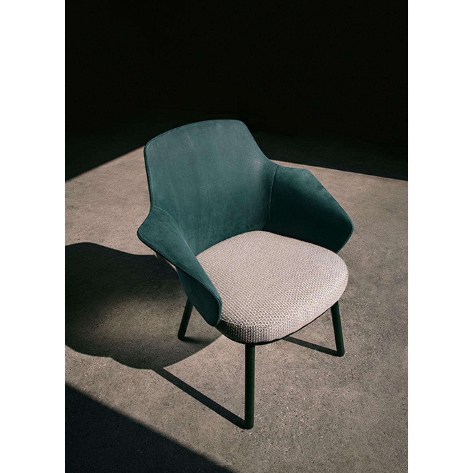 Linus armchair by Marco Dessí
Materials: Upholstery: Fabric (also available in leather please contact us)
Structure: Wood: Noce Canaletto solid wood, Coral/Dark green/Black stained wood
 Also available metal: Black powder-coated metal, black