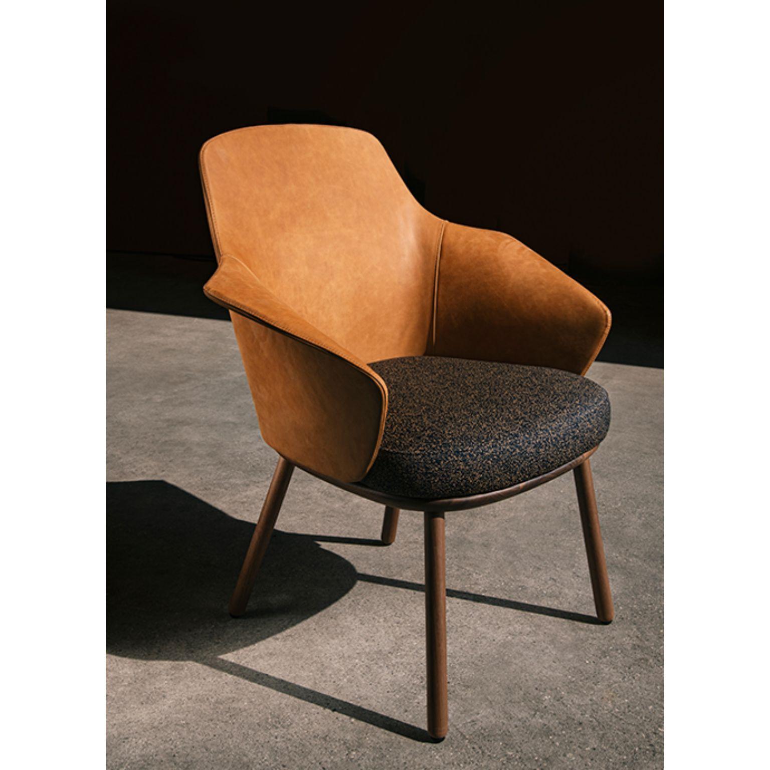 Linus armchair by Marco Dessí
Materials: Upholstery: Fabric
Structure: Wood: Noce Canaletto solid wood, coral/dark green/black stained wood
 Also available metal: Black powder-coated metal, black chrome metal

Dimensions: W71.9 x D60.2 x H86.3