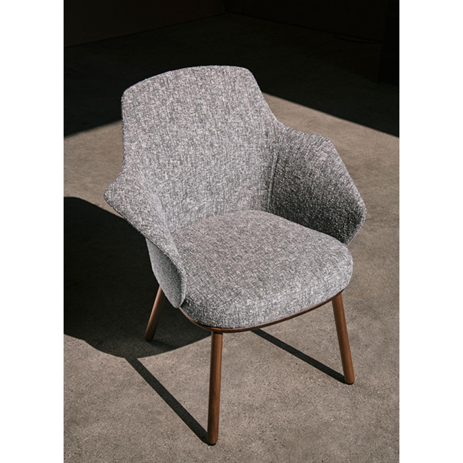 Linus armchair by Marco Dessí
Materials: Upholstery: Fabric (also available in leather)
Structure: Wood: Noce Canaletto solid wood, Coral/Dark green/Black stained wood
 Also available Metal: Black powder-coated metal, Black chrome