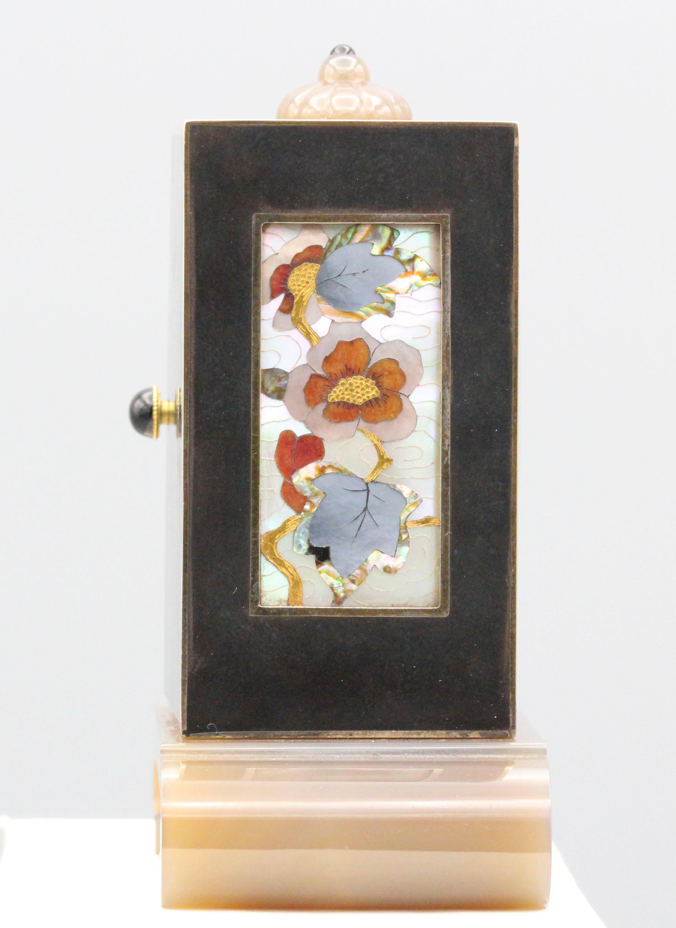 Exceptional and one of a kind clock by Linzeler Marchak .  Case is gold with black enamel, and features Asian characters hour markers; top and bottom of the clock decorated with agate.  The clock dial is carved and inlaid Mother of Pearl with