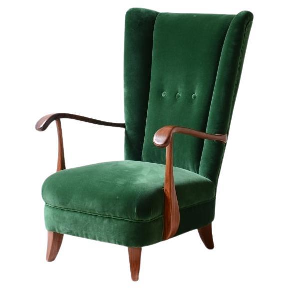 Lio Carminati, elegant armchair in shaped wood For Sale