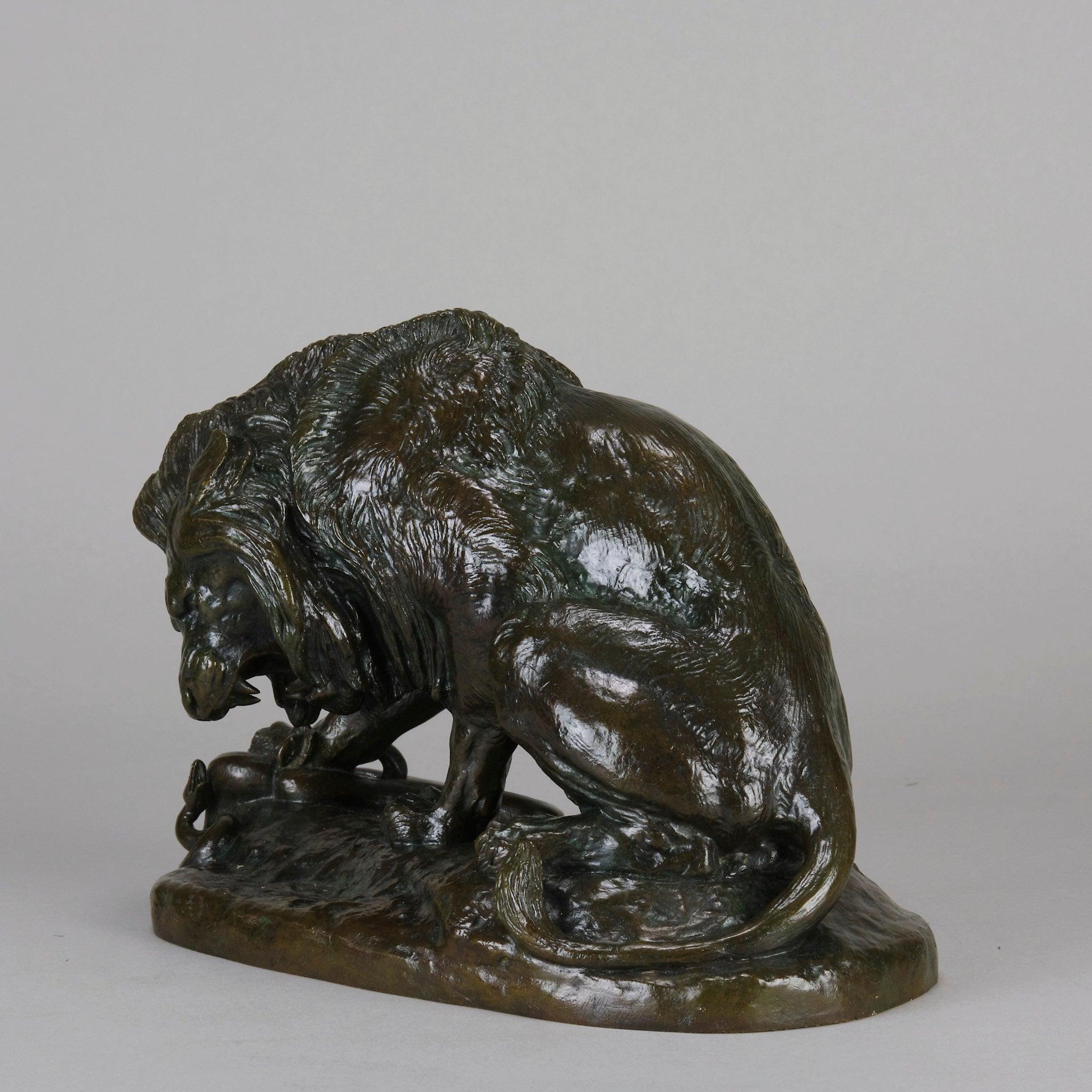 A powerful and impressive French Animaliers bronze study of a Lion holding down a snake beneath his paw, with excellent hand chased surface detail and rich brown and green patination in variegated shades to the raised areas, signed BARYE. A rare