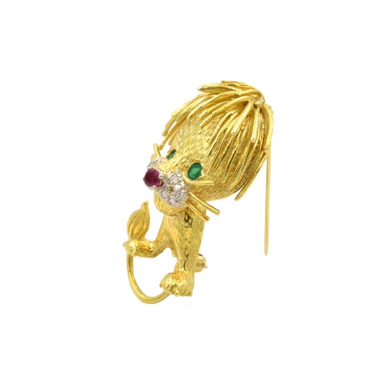 Whimsical 18k yellow gold 1960s lion brooch with a single cut diamond snout, ruby nose, and emerald eyes.  An inch and a half tall. 

