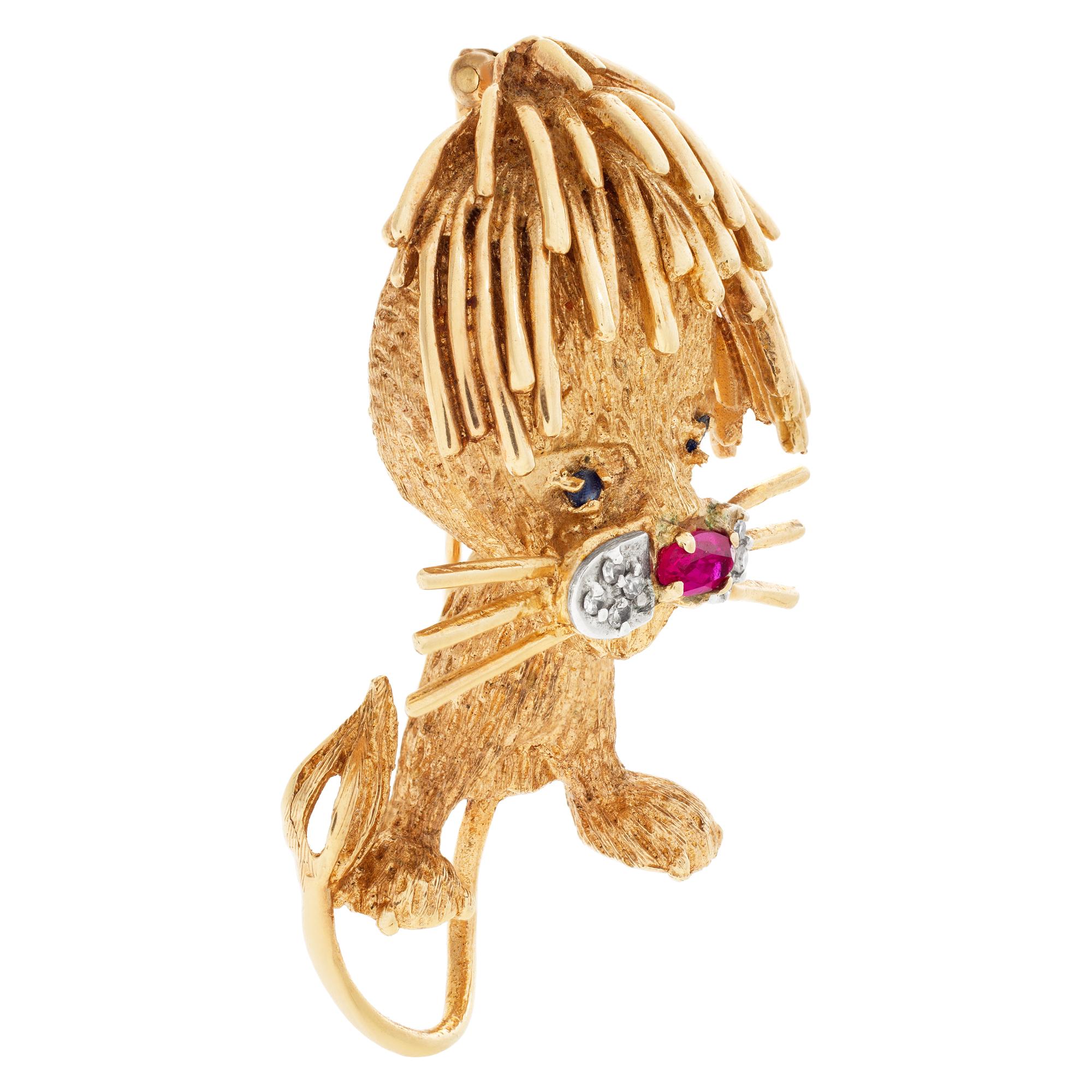 Fancy lion cub brooch in 14k gold with an oval ruby nose, diamond whiskers and emerald eyes. Dimensions 44.5 mm length x 26.5mm width.
