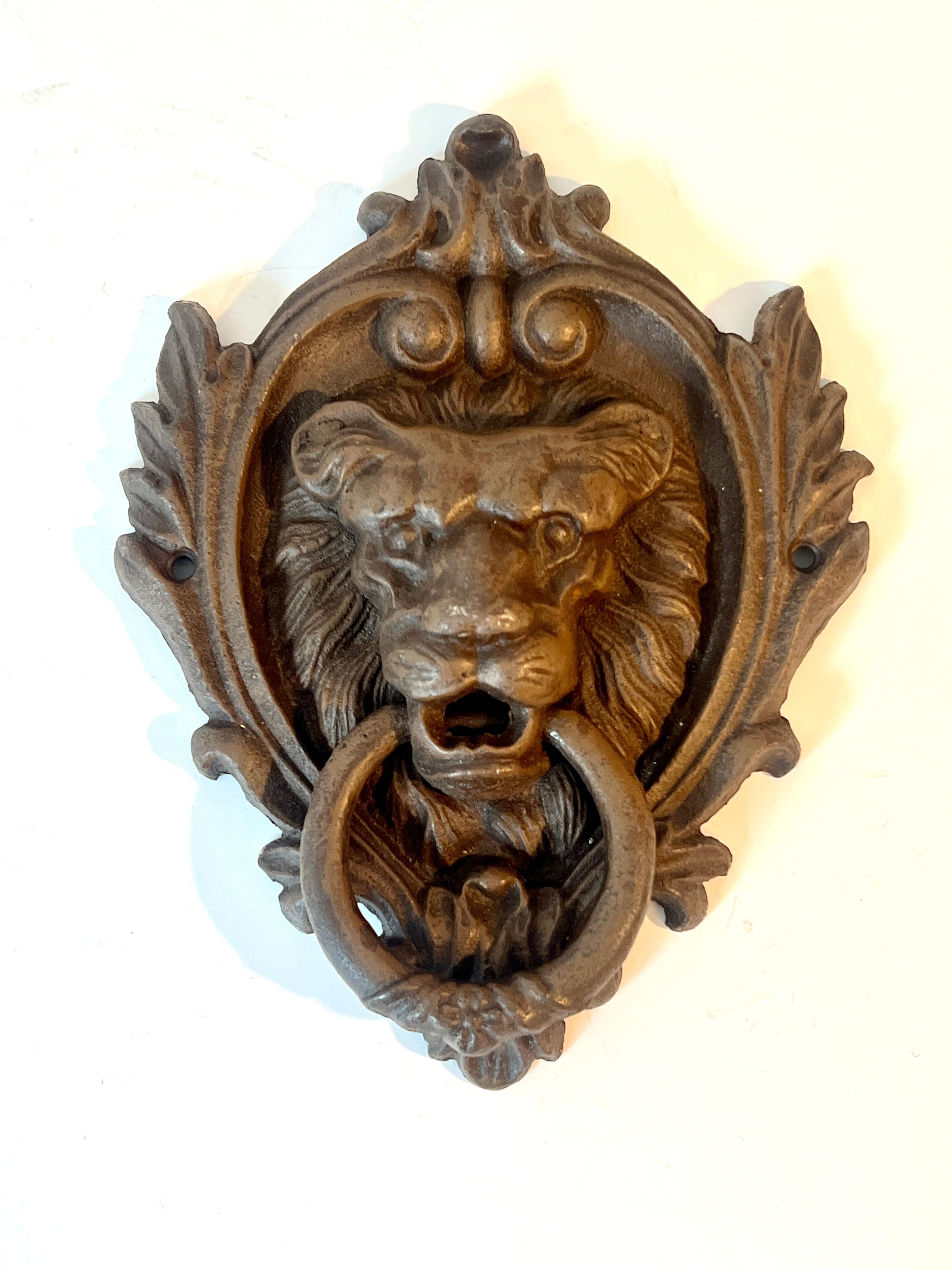 A very large door knocker with Lion as focal point - a generous and embellished framework gives the piece a great deal of character and importance - in cast iron with a wonderful brown tone patinated finish.

We have found the price guidance tool is