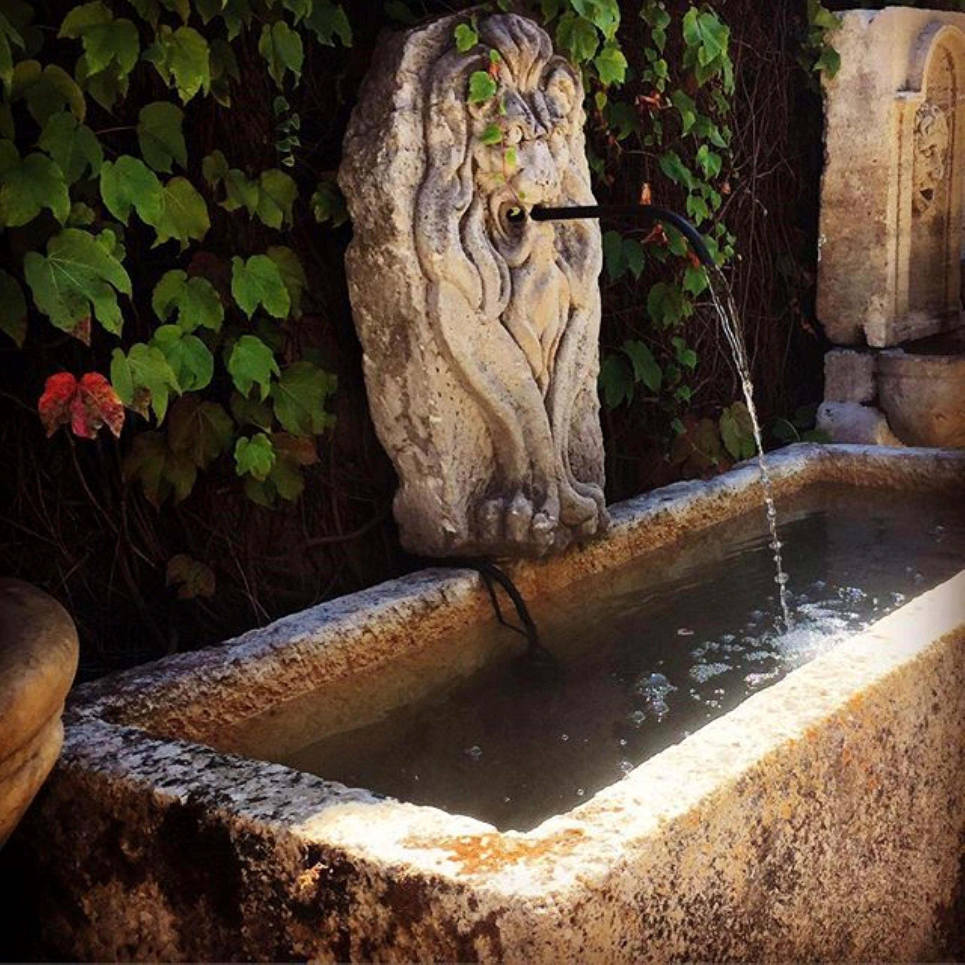 19th century large sculpture hand carved stone fountain head of a lion. It could be installed with a simple water spout or as is. You can pair it with a stone trough basin to create a charming garden water fountain feature we have many available