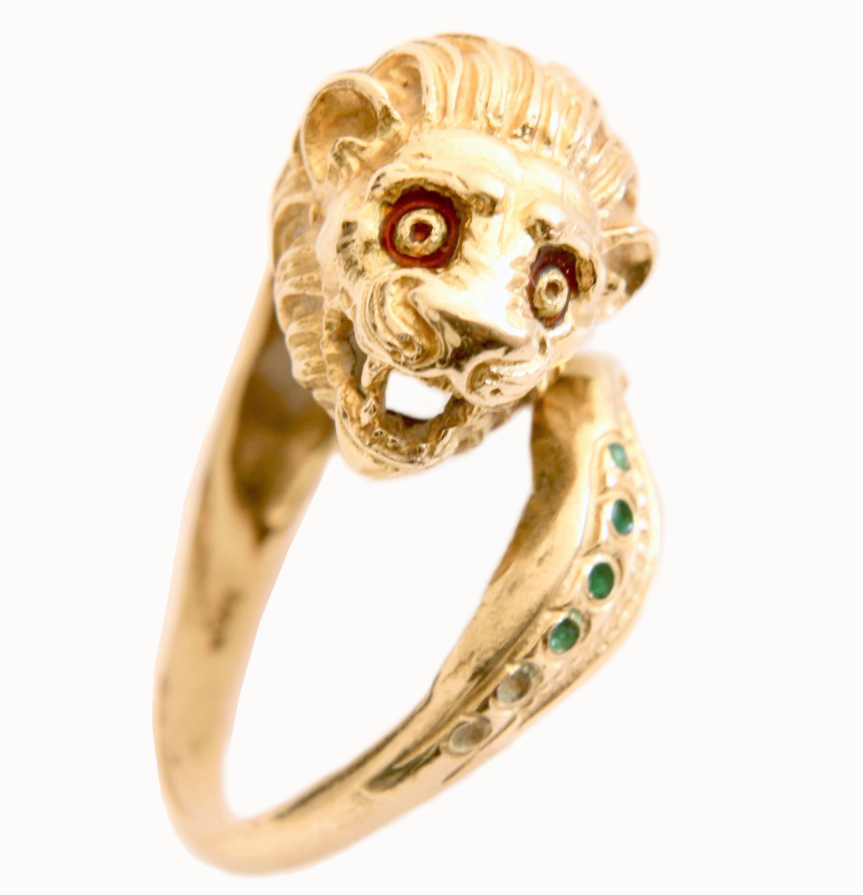 Here's a cool vintage lion head ring, most likely made in the 1960s.  Made from 18 carat gold, this eye-catching piece features emerald green enamel accents as the mane and tail, with red enamel surrounding the eyes.  

Perfect for the Leo in your