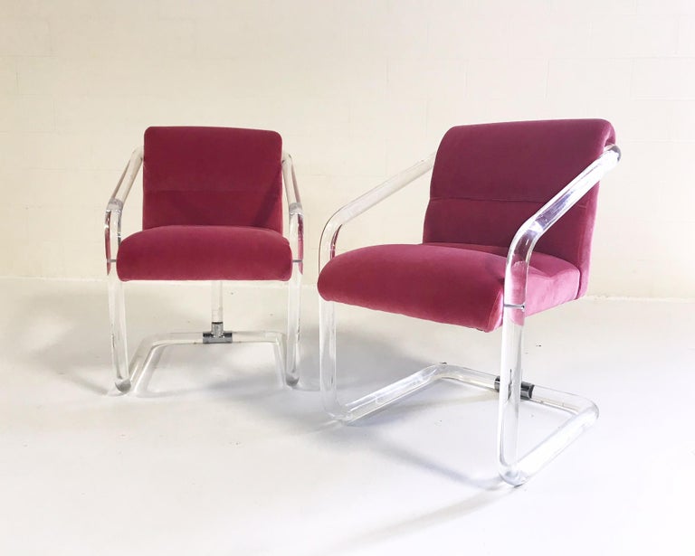 We love the design of this Lucite pair. The center leg stemming from the seat adds a bit of interest to the overall simple design. Our design team chose a gorgeously fun and Classic Loro Piana fuschia pink velvet for restoration. Included with the