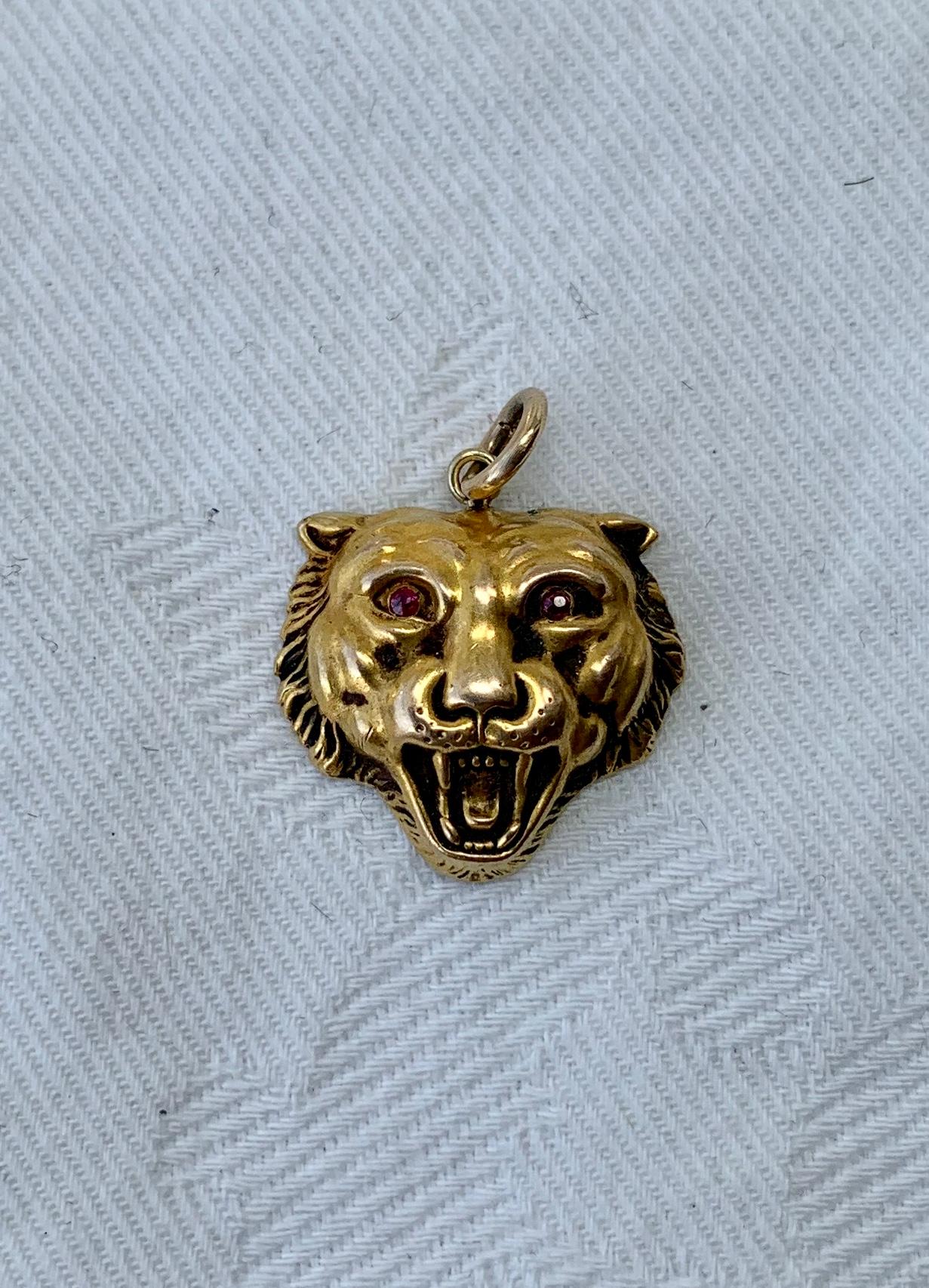 A wonderful antique Belle Epoque, Victorian pendant with a beautifully modeled lion, leopard or panther in 14 Karat Gold with two Ruby eyes.  We love our panther, lion, cat jewelry and this one has such stunning design.   The repousse raised and