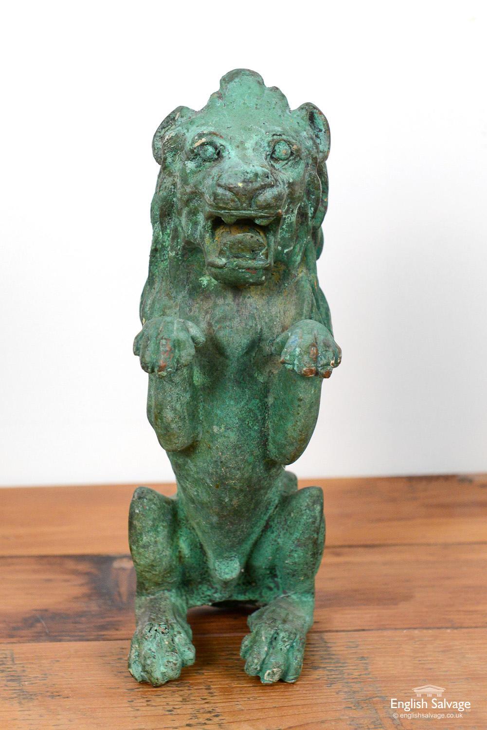 Cast bronze sculpture of a lion on his haunches, in the heraldic rampant position, with an oxidized finish. One rear leg is slightly bent, otherwise good condition.