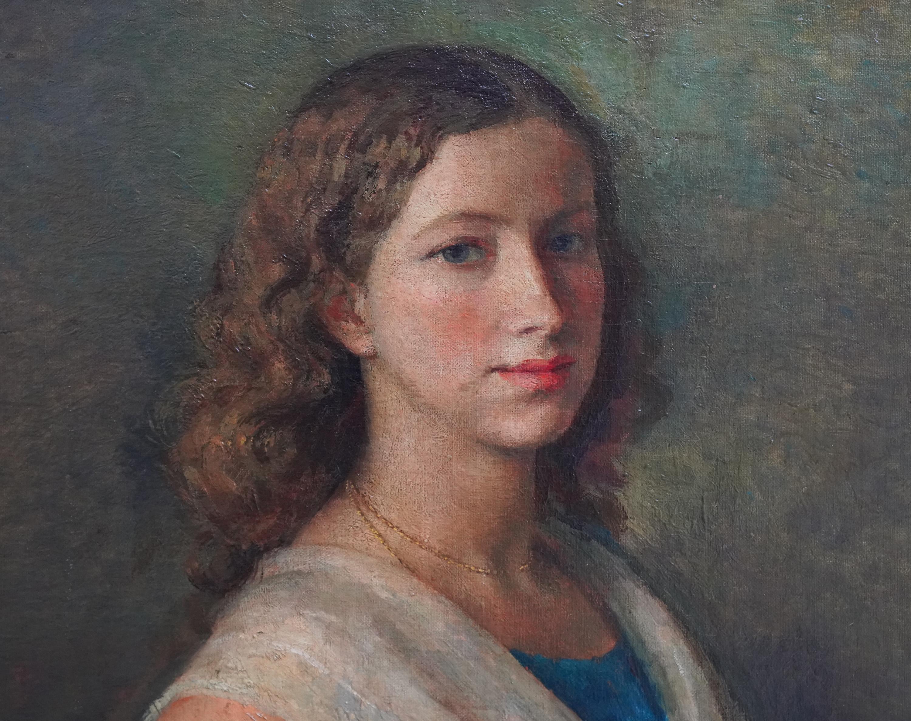 This lovely British portrait oil painting is by noted artist Lionel Ellis. Painted in 1929 it is a half length standing portrait of a young woman in a blue dress with a white lace shawl. She has her hand on her hip and is turning to gaze at the