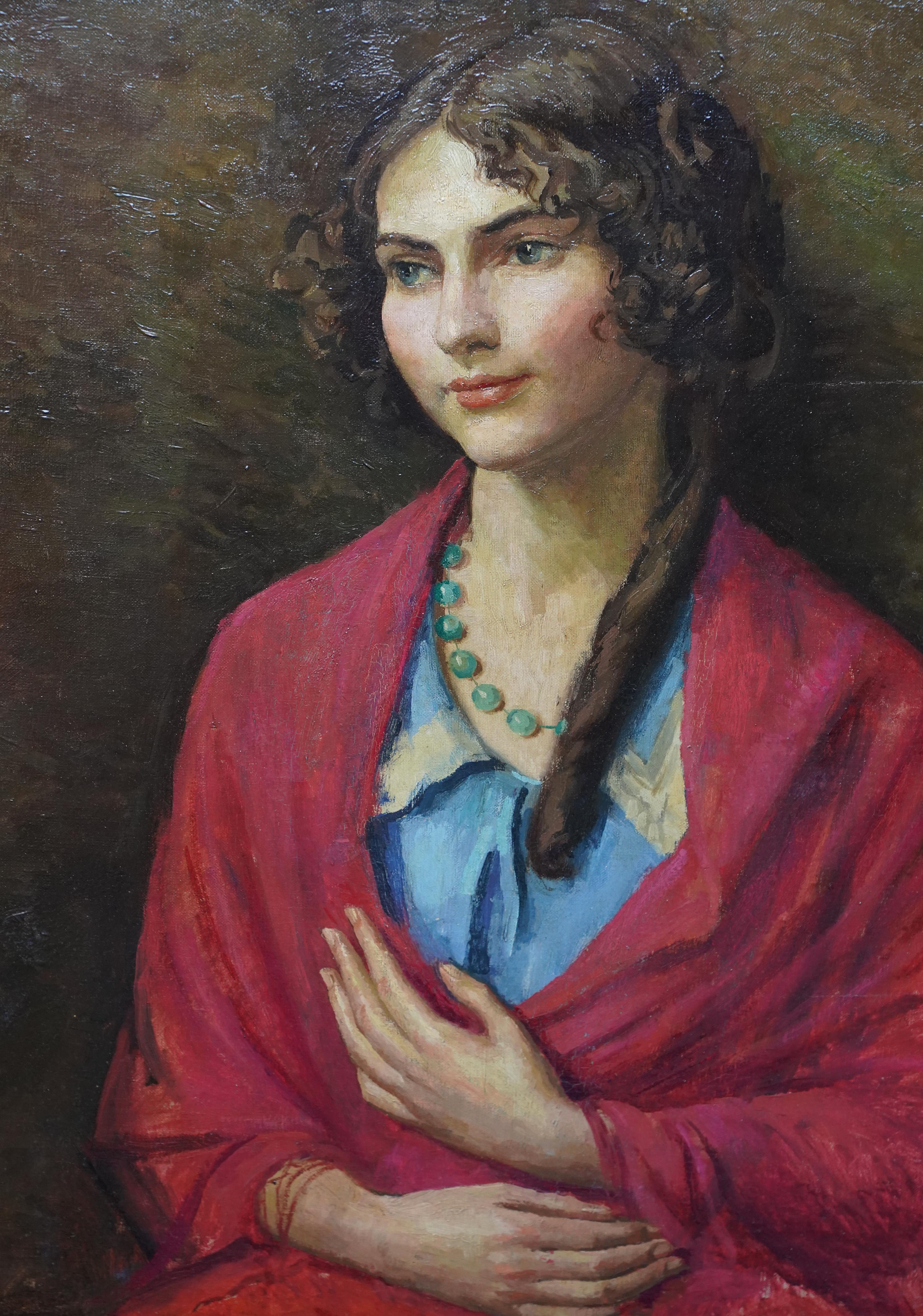 This lovely British portrait oil painting is by noted artist Lionel Ellis. Painted circa 1940, the picture is a half-length seated portrait of a smiling woman wrapped in a red shawl, her dark hair cascading down one shoulder in a long ringlet. There