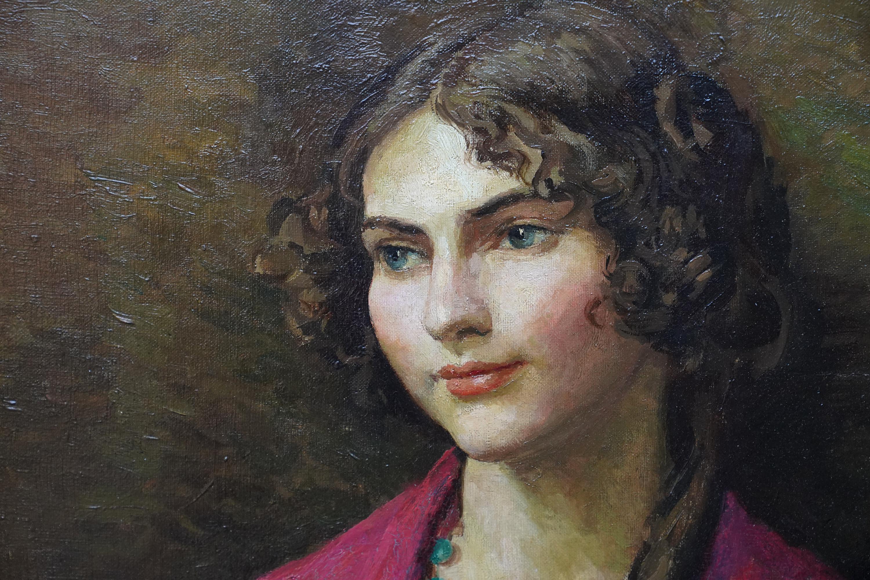 This lovely British portrait oil painting is by noted artist Lionel Ellis. Painted circa 1940, the picture is a half-length seated portrait of a smiling woman wrapped in a red shawl, her dark hair cascading down one shoulder in a long ringlet. There