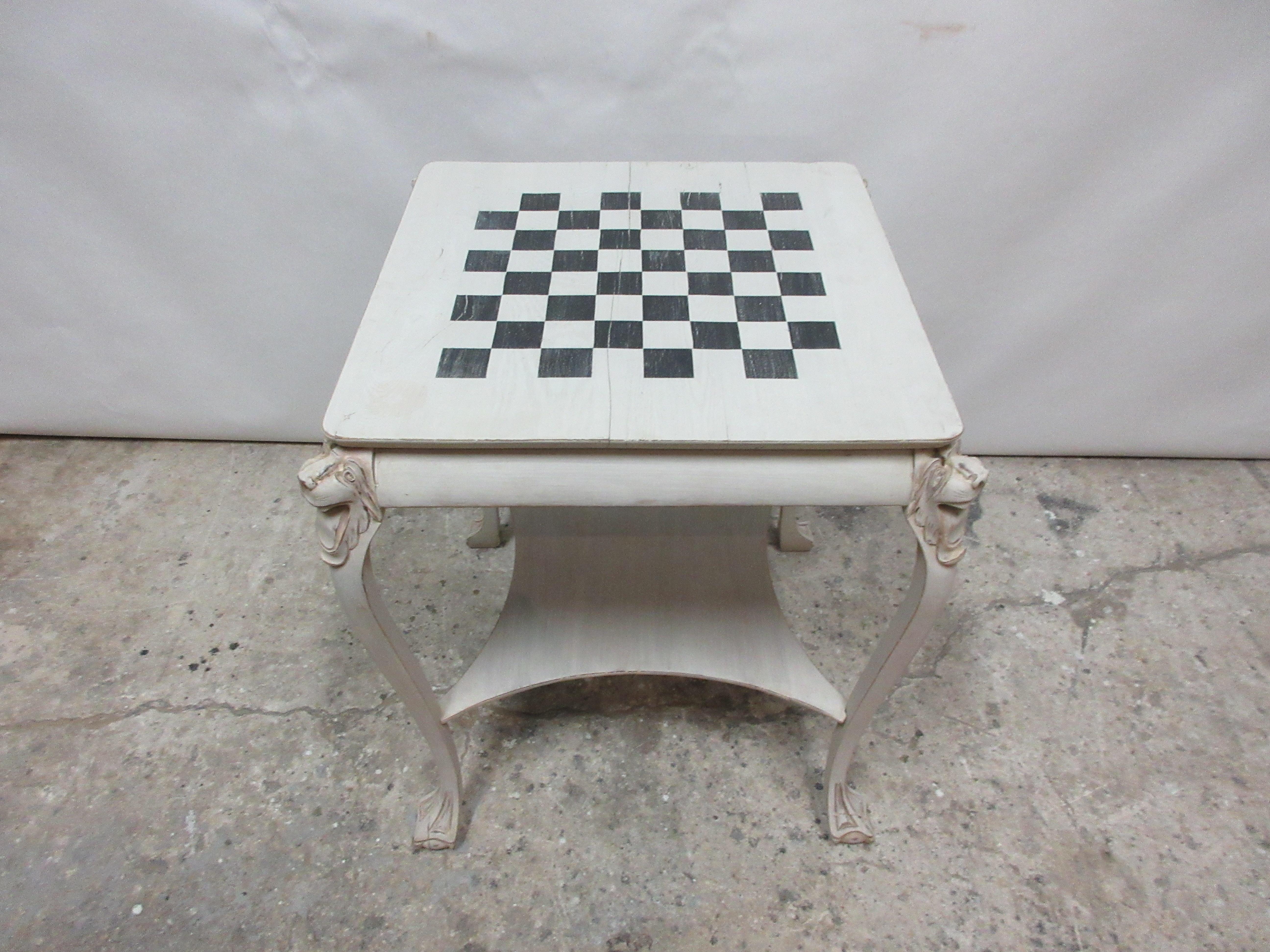 This is a lions head chess table, its been restored and repainted with milk paints 
