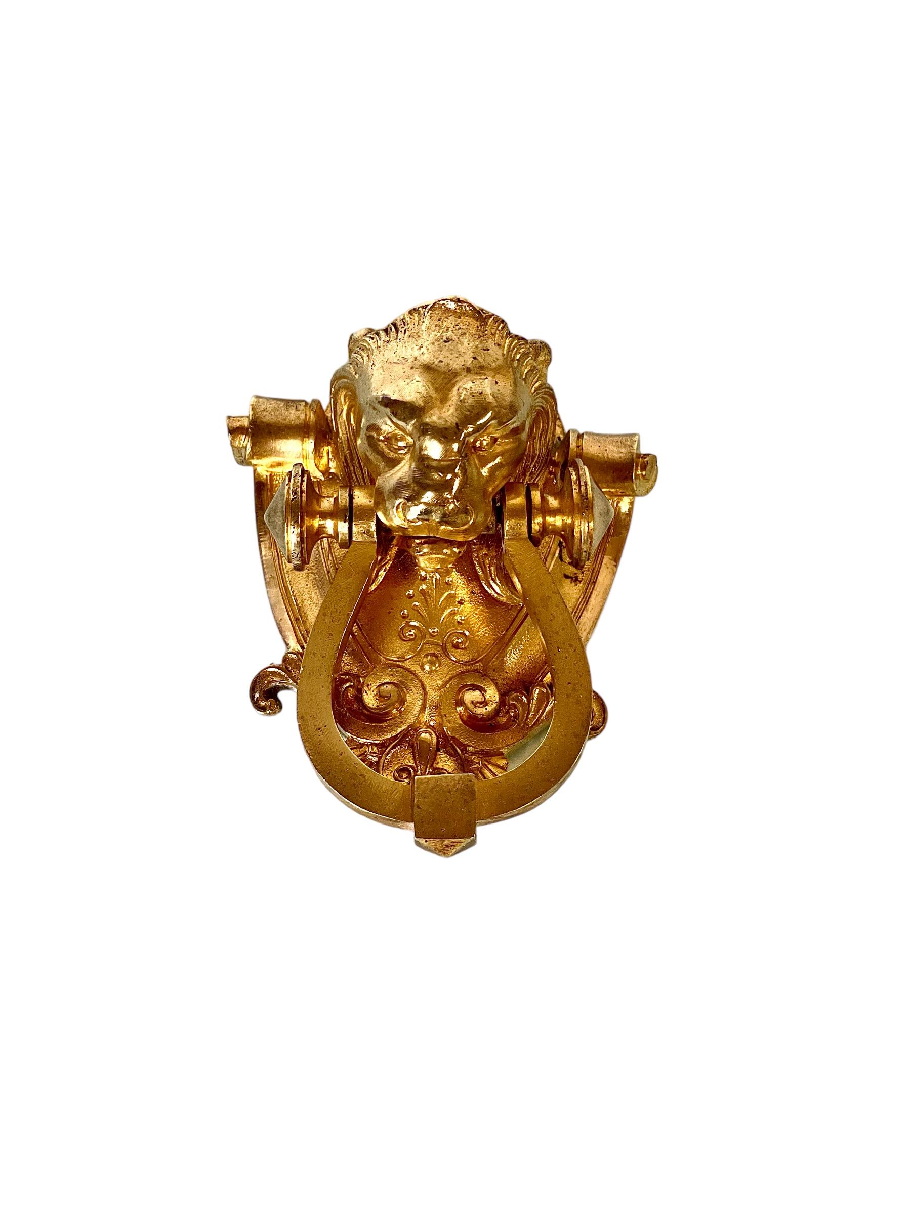 A fabulous antique lion's head door knocker in gilt bronze, dating from the 19th century. Traditionally regarded as the king of beasts, the lion's head symbolises power, strength, pride and protection, and has been a popular choice as the theme for