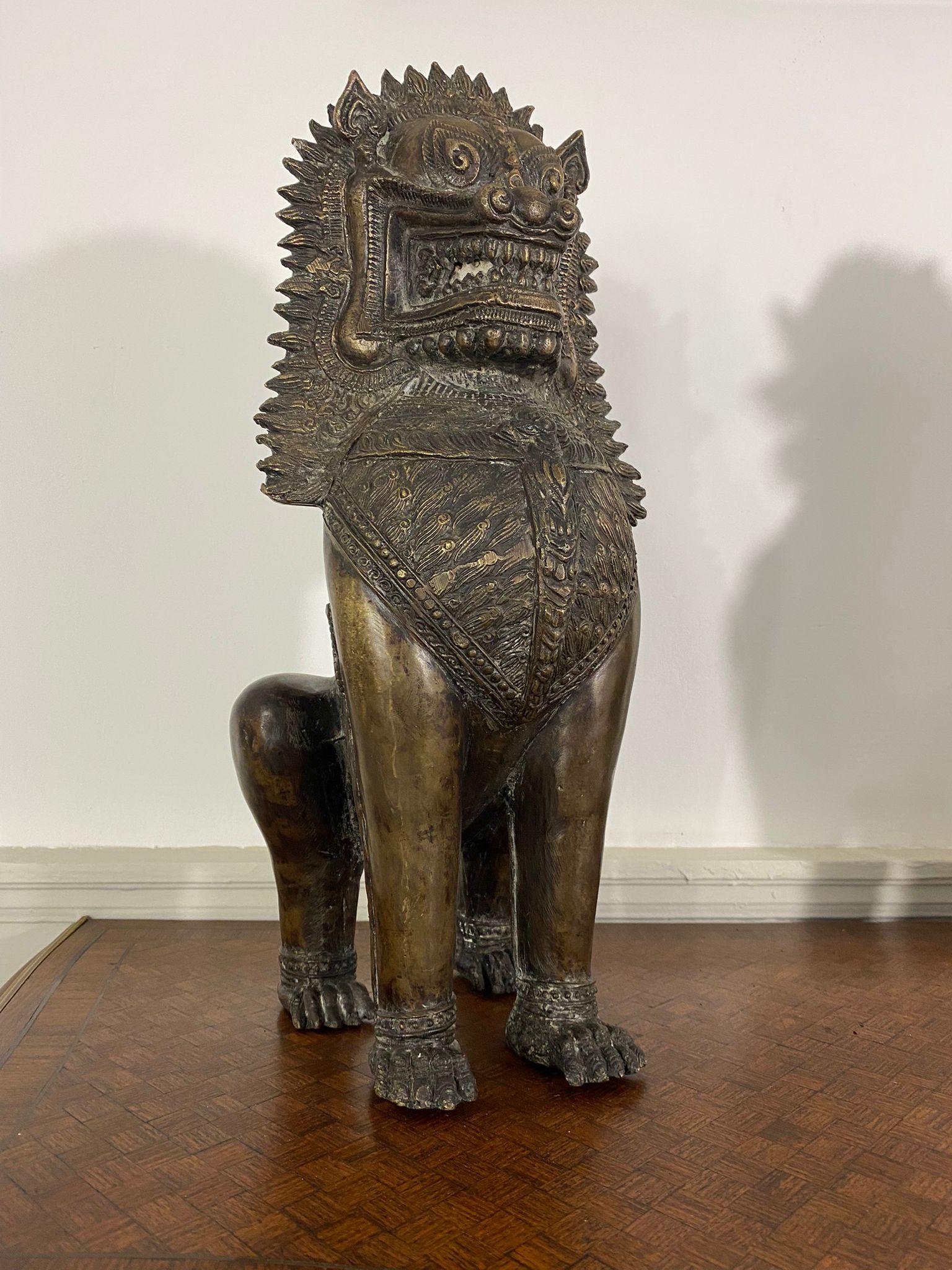 Pair of large temple guardians from the Thai art of Rattanakosin. These two temple guardians represent lions. They have a warrior look with their kind of armour on the chest but also on the back of the legs. These statues are made of bronze. 

The