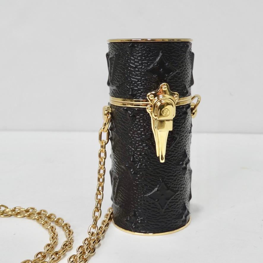 Get your hands on this incredible Louis Vuitton lipstick case! The most unique accessory in a rare and eye catching embossed black leather featuring gold tone hardware and a crossbody style chain attached. Never again go an evening without the