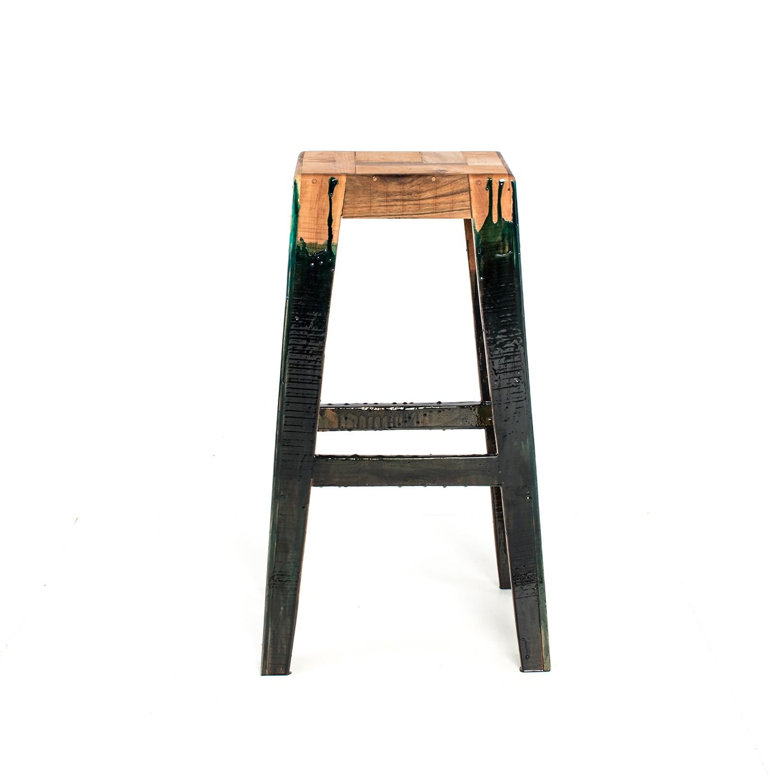 The bar stool is made of an antique piece of walnut wood floorboard, handcrafted Elmwood, and Plexiglass. The footrest heights are all different to accommodate all ages and heights. 

Materials: Walnut, Alder and Oak, Acrylic, Brass and Resin.