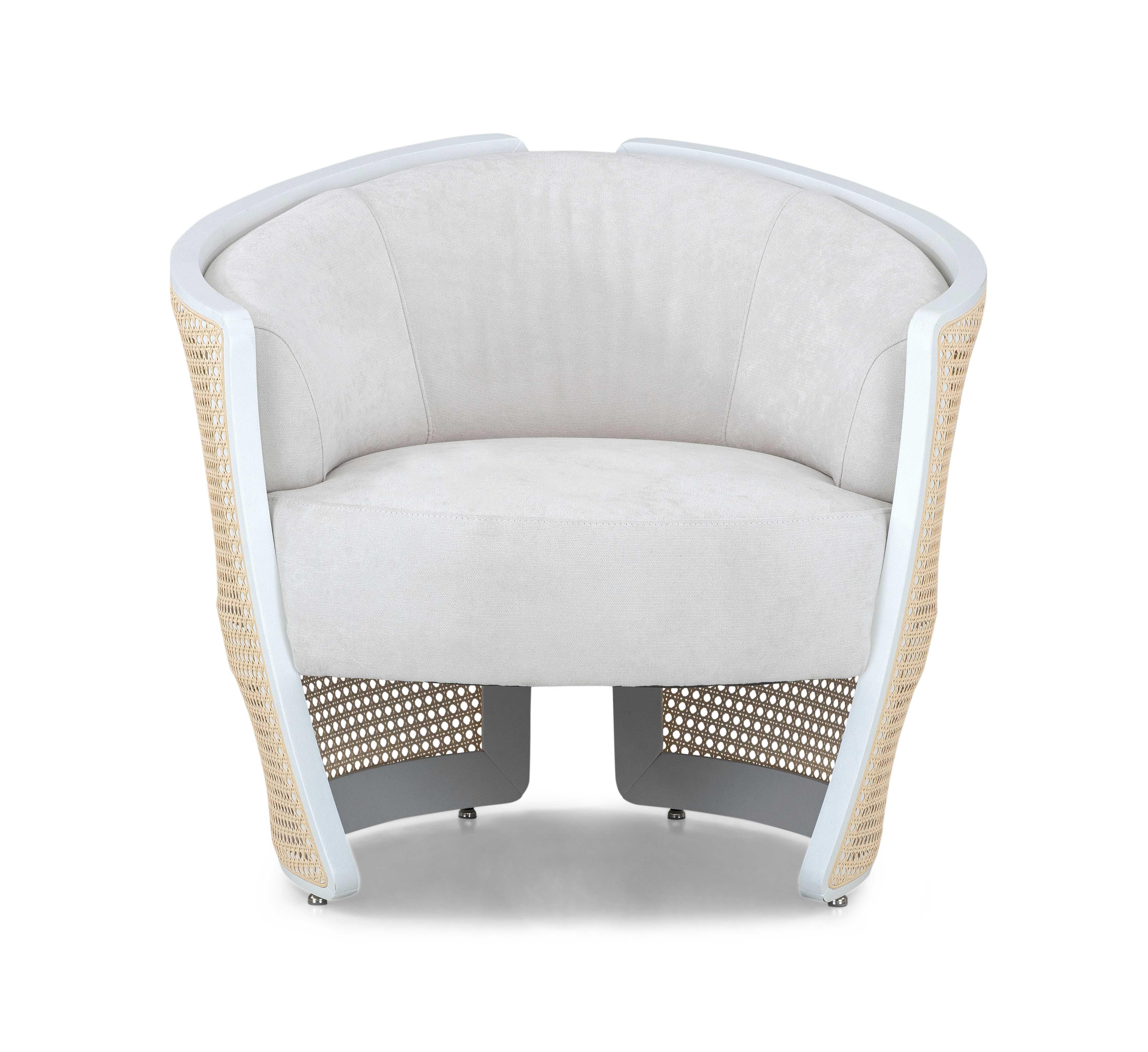 A Lirio armchair designed by Uultis Studio with white matte finish, white fabric and natural cane accents. *Please check availability prior to purchase*.

The Lirio armchair combines exquisite craftsmanship with a modern aesthetic, creating a