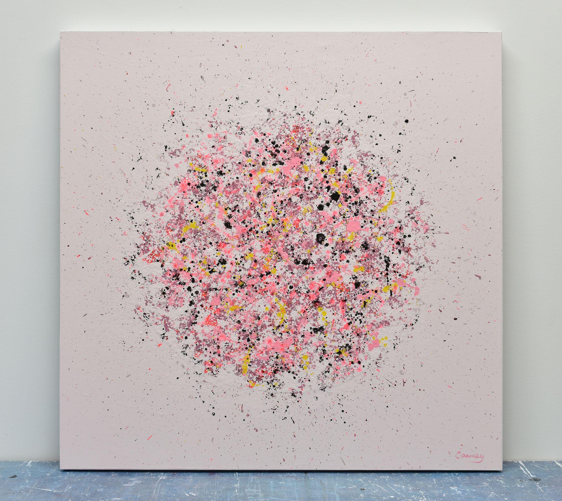 Petal Burst 37 is an abstract painting in acrylic on canvas. Various shades of pink, coral, yellow and black explode onto a pale pink background. It is part of the Petal Burst series, a collection of floral abstract paintings where drip and spatter