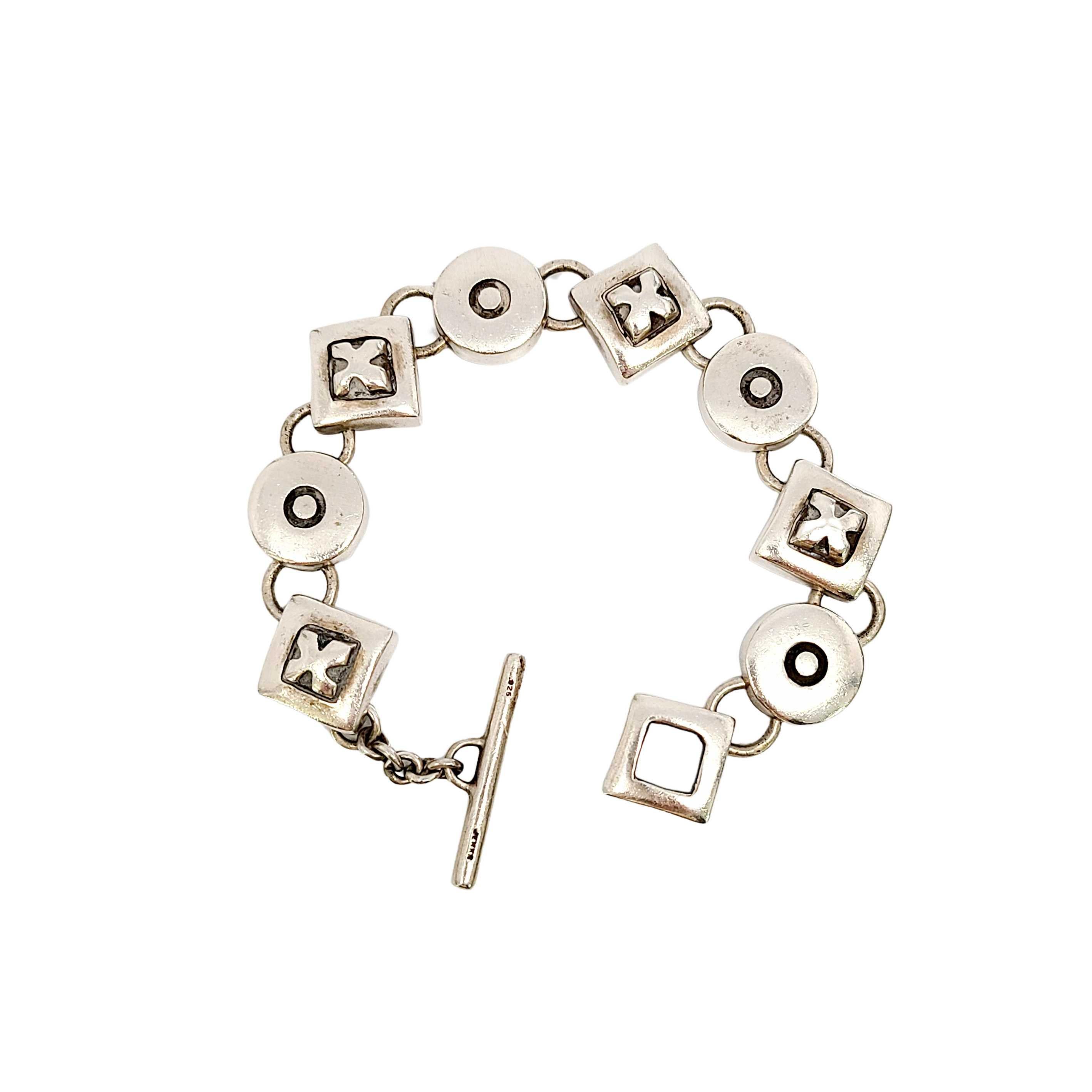 Lisa Jenks sterling silver geometric XO link bracelet.

Bold, modernist and distinctive Jenks design, features alternating X and O links, and a toggle closure.

Measures approx 7 1/2