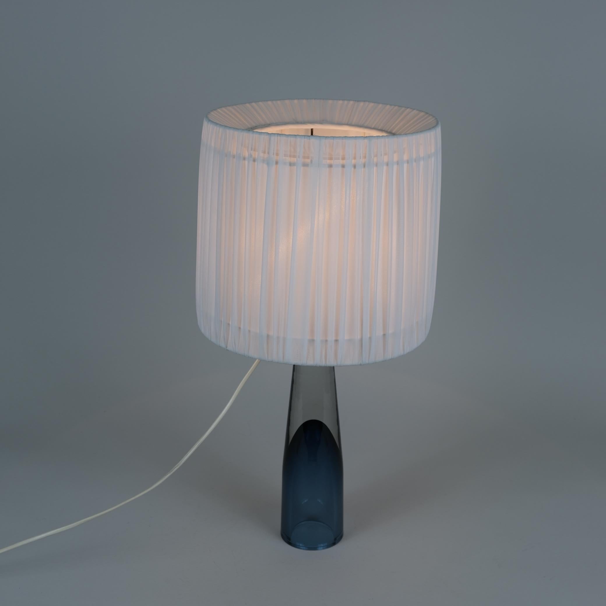 A beautiful blown glass table lamp designed by Lisa Johansson-Pape and manufactured by Orno, in Finland in the 1950s. The handmade art glass was free blown in Iittala, one of the leading art glass manufacturers in Finland. This model is usually