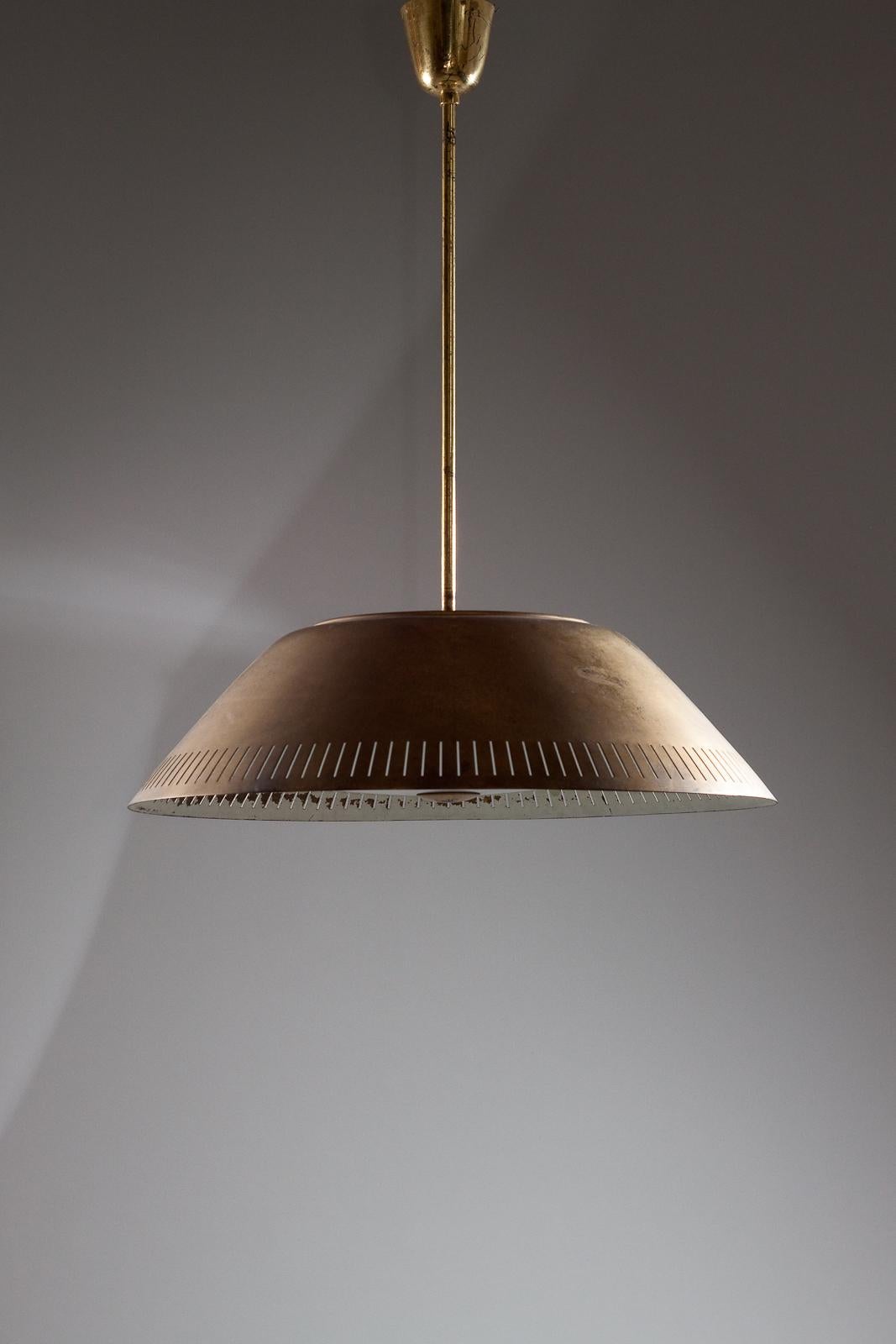 This stunning pendant light from Lisa Johansson-Pape is a rare design, crafted from solid brass. With a large scale of 60 cm in diameter, it will make a bold and striking statement in any room. This pendant is made for ORNO, a renowned Finnish