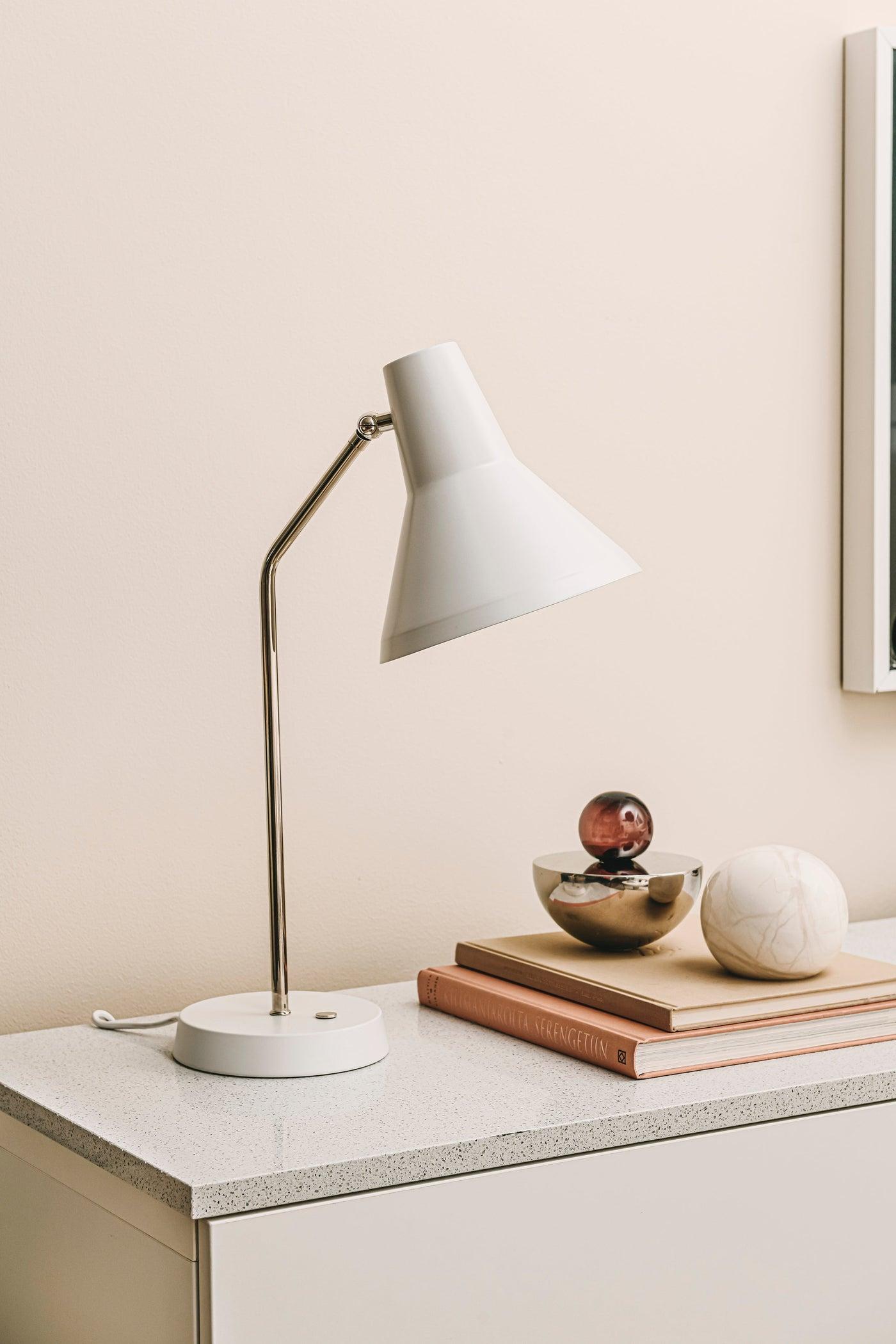 Lisa Johansson-Pape 'Carin' table lamp in brass for Innolux. 

Innolux Carin is a new family of luminaires with a sophisticated look sealed by a brass or chrome arm. The beautiful metal dome is easy to direct and the practical touch switch brings a