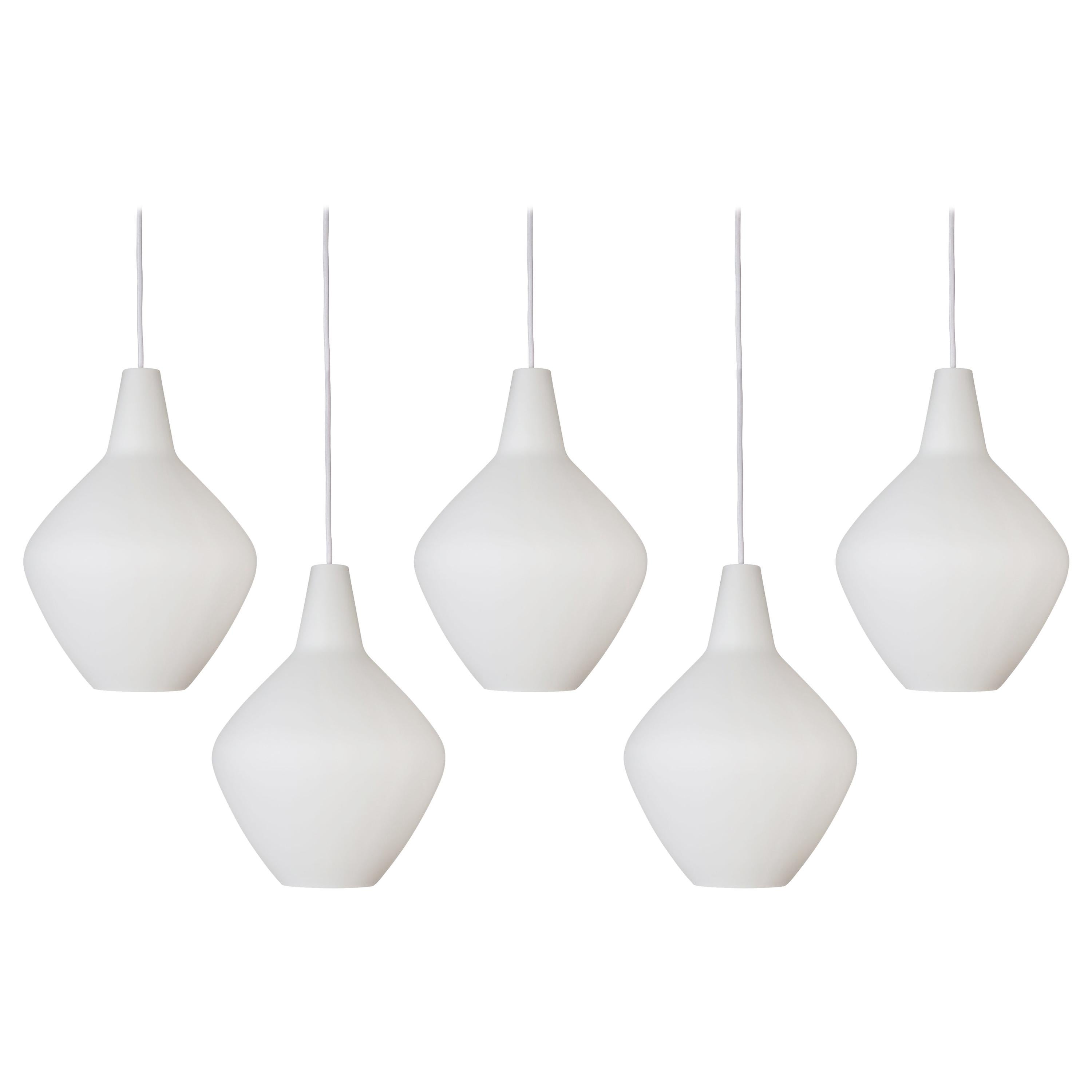 Lisa Johansson-Pape glass 'Onion' pendants. Hand blown in thick opaline glass with thick white cloth cord. Authorized re-edition by Innolux Oy, Finland.

Price is per item. One in stock. Out of stock lead time 3-4 weeks or more. Please note that