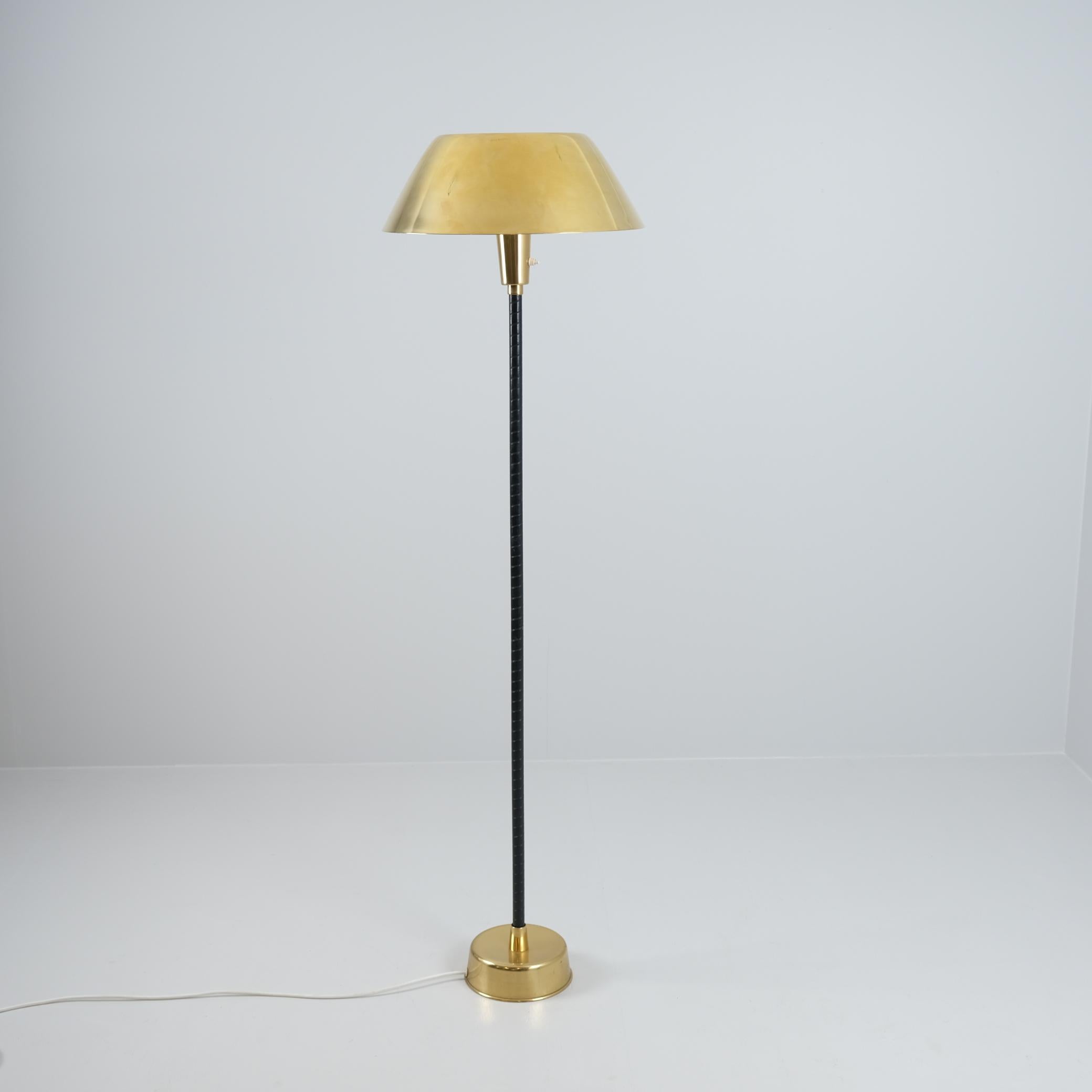 A beautiful example in a brass/metal base, original black nylon covered stem, and an acrylic and brass shade.

This `Ihanne` lamp became very popular in Finland with many different variations of stems, materials and shades. It was used in public