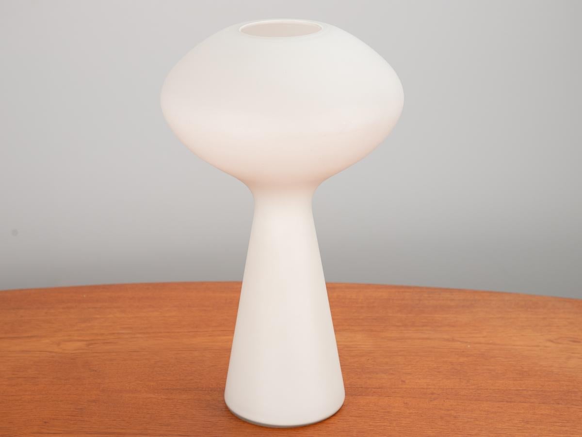 Organic modern table lamp, designed by Lisa Johansson-Pape. Handblown glass is shaped in a pleasing yet playful mushroom form. Lovely opaline quality to the glass. An elongated form, this is the larger version of this design. In good condition, with