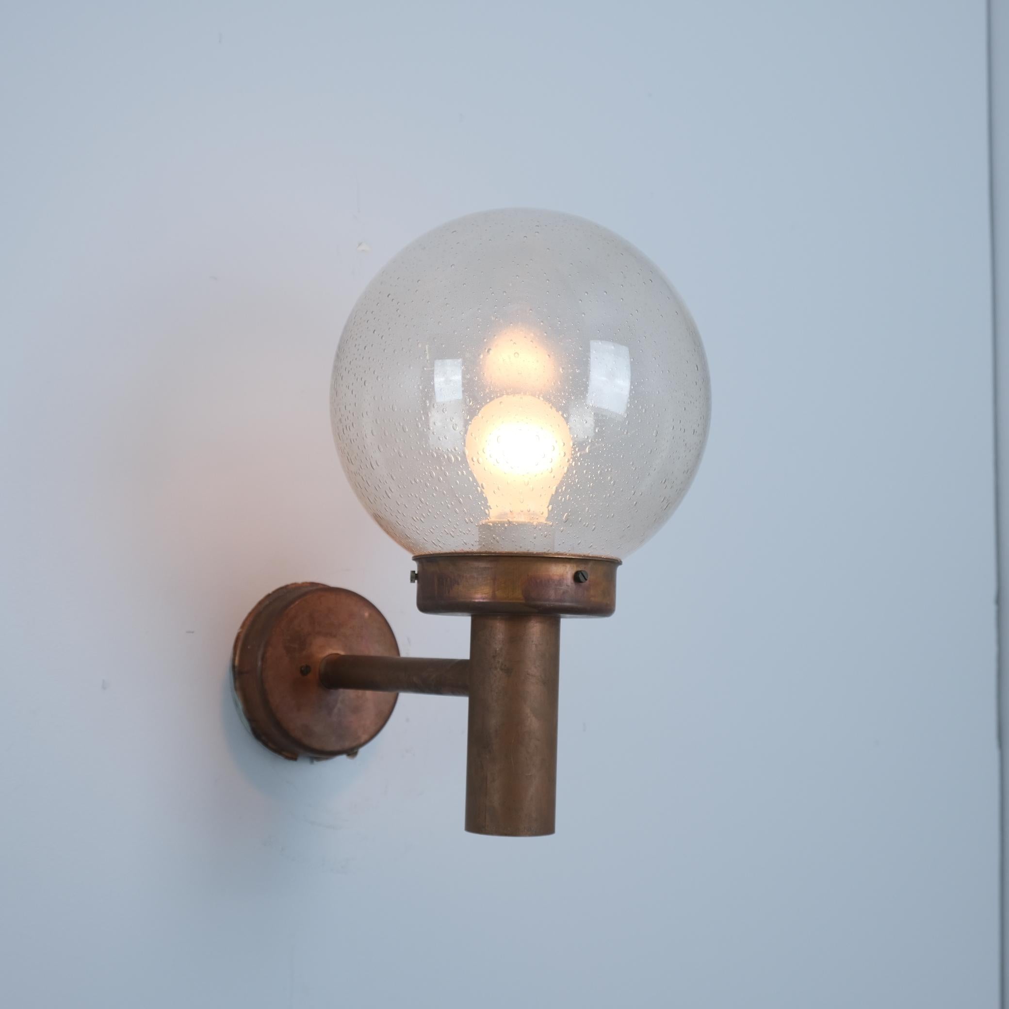 An outdoor wall lamp designed by Lisa Johansson-Pape and manufactured by Orno Oy, in the 1950s in Finland. In fully original condition featuring a nice patina. The item is stamped by the manufacturer 