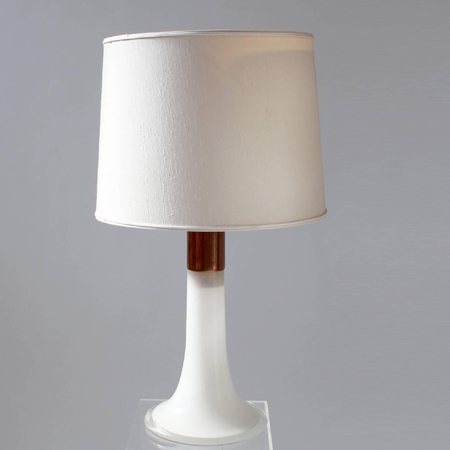 A sculptural and rare pair of Lisa Johansson-Pape table lamps model 46-017.

Very good original condition, including the inner shades which makes this lamp extraordinary. 

Opal glass, copper and fabric lampshade.

Ornö Edition 1961