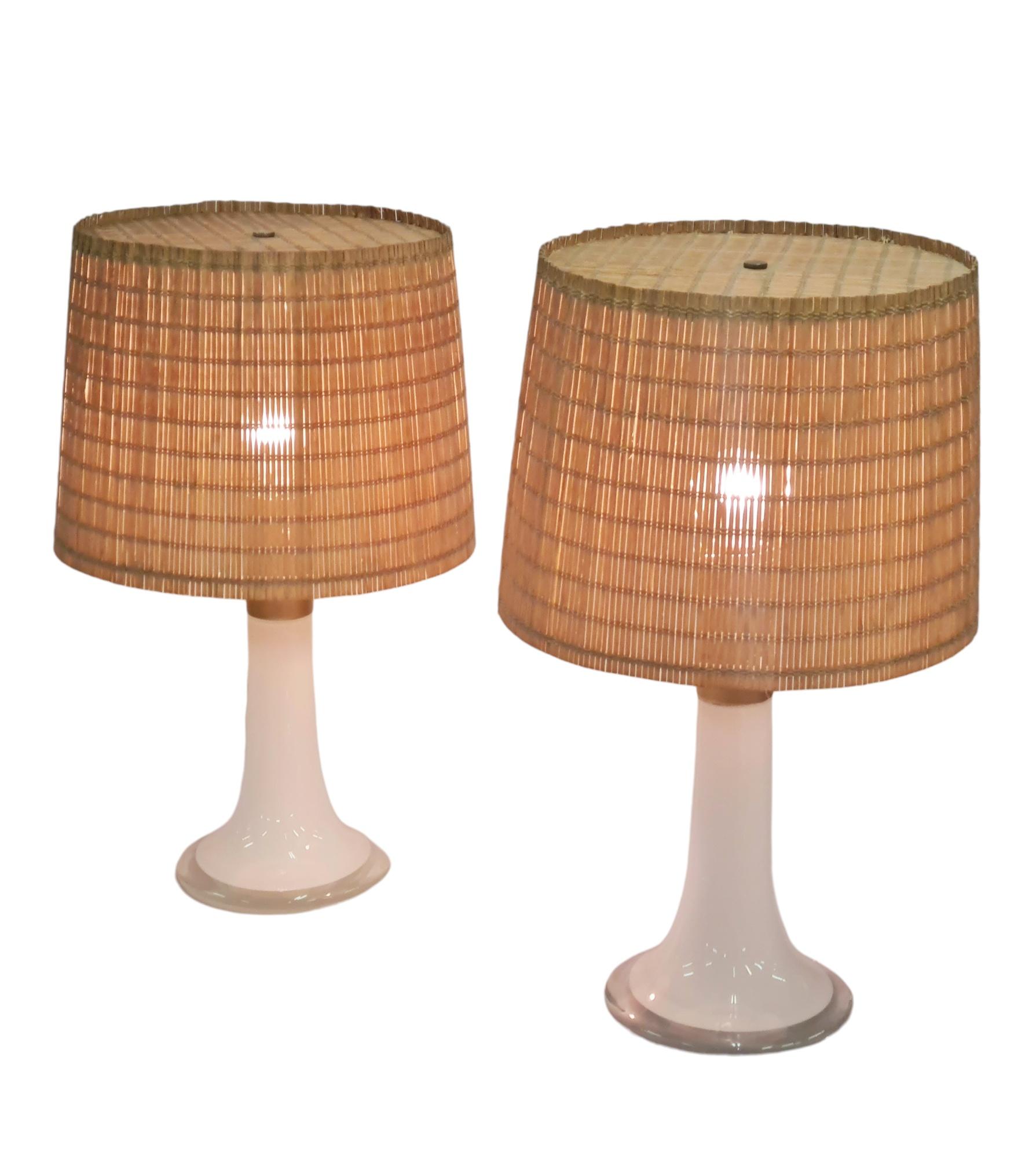 A pair of table lamps model 46-017 in metal and opaline glass designed by Lisa Johansson-Pape and manufactured by Orno Oy In Finland in the 1960s. This simple yet elegant design is one of the most well known designs from the renowned Lisa