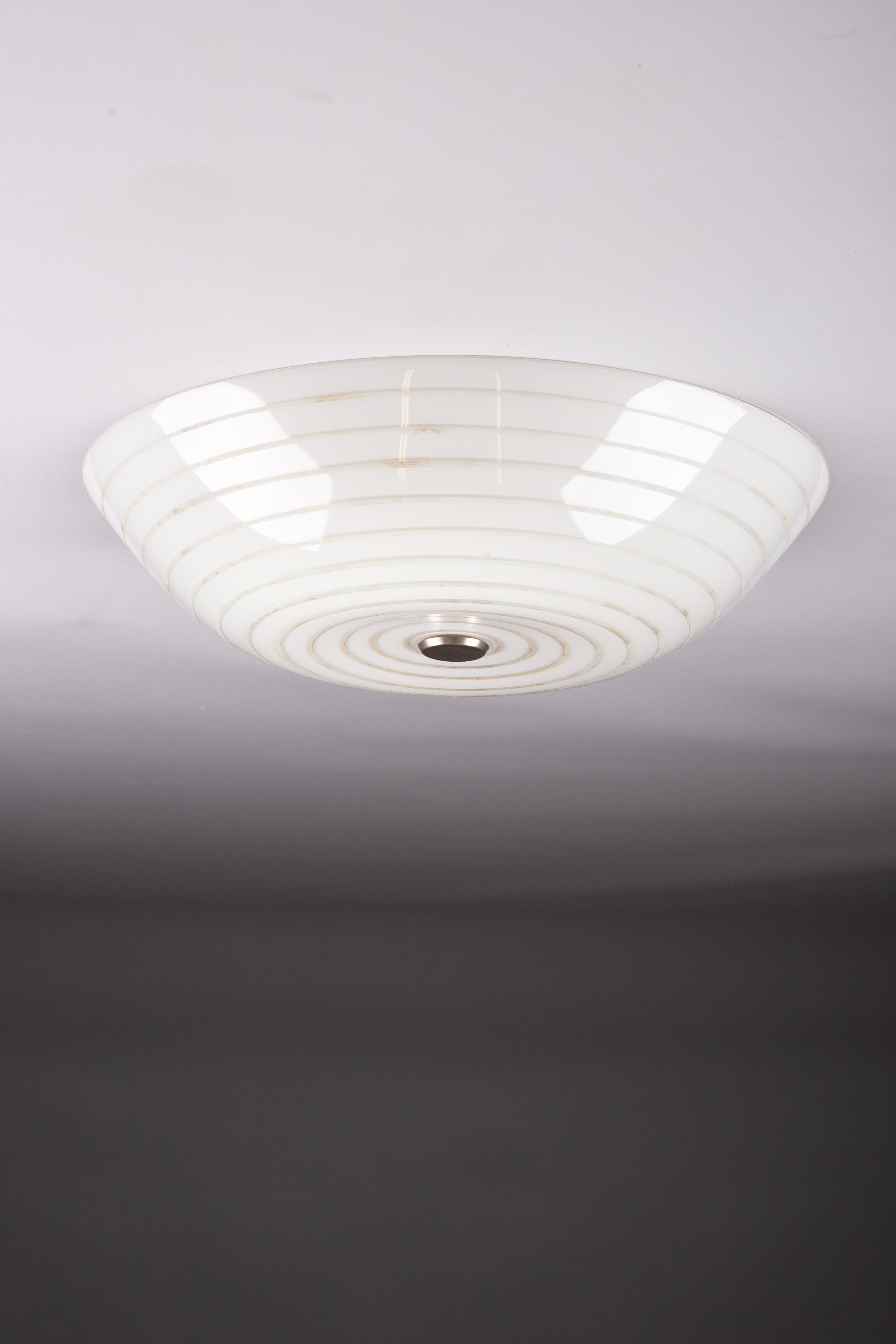 Discover timeless elegance with this rare 1950's hand-painted flush mount, a masterpiece by Lisa Johansson-Pape for ORNO, Finland. This vintage gem embodies the essence of Scandinavian design with its meticulous craftsmanship and artistic detailing.