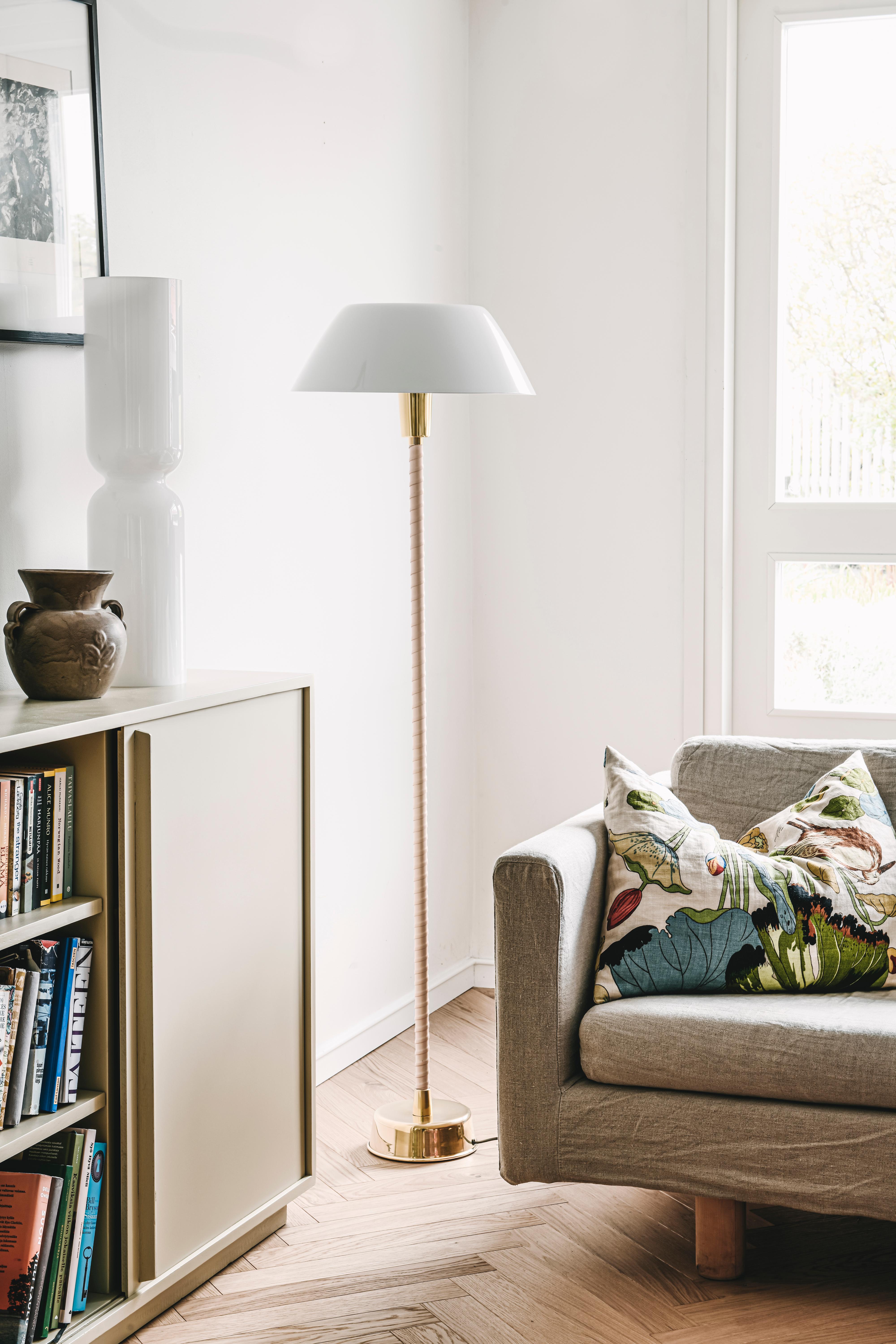 Lisa Johansson-Pape 'Senator' floor lamp in white for Innolux Oy. 

An iconic lamp design by the Finnish master executed in brass, painted aluminum shade, acrylic diffuser and hand-wrapped leather. An authorized re-edition made to exacting standards