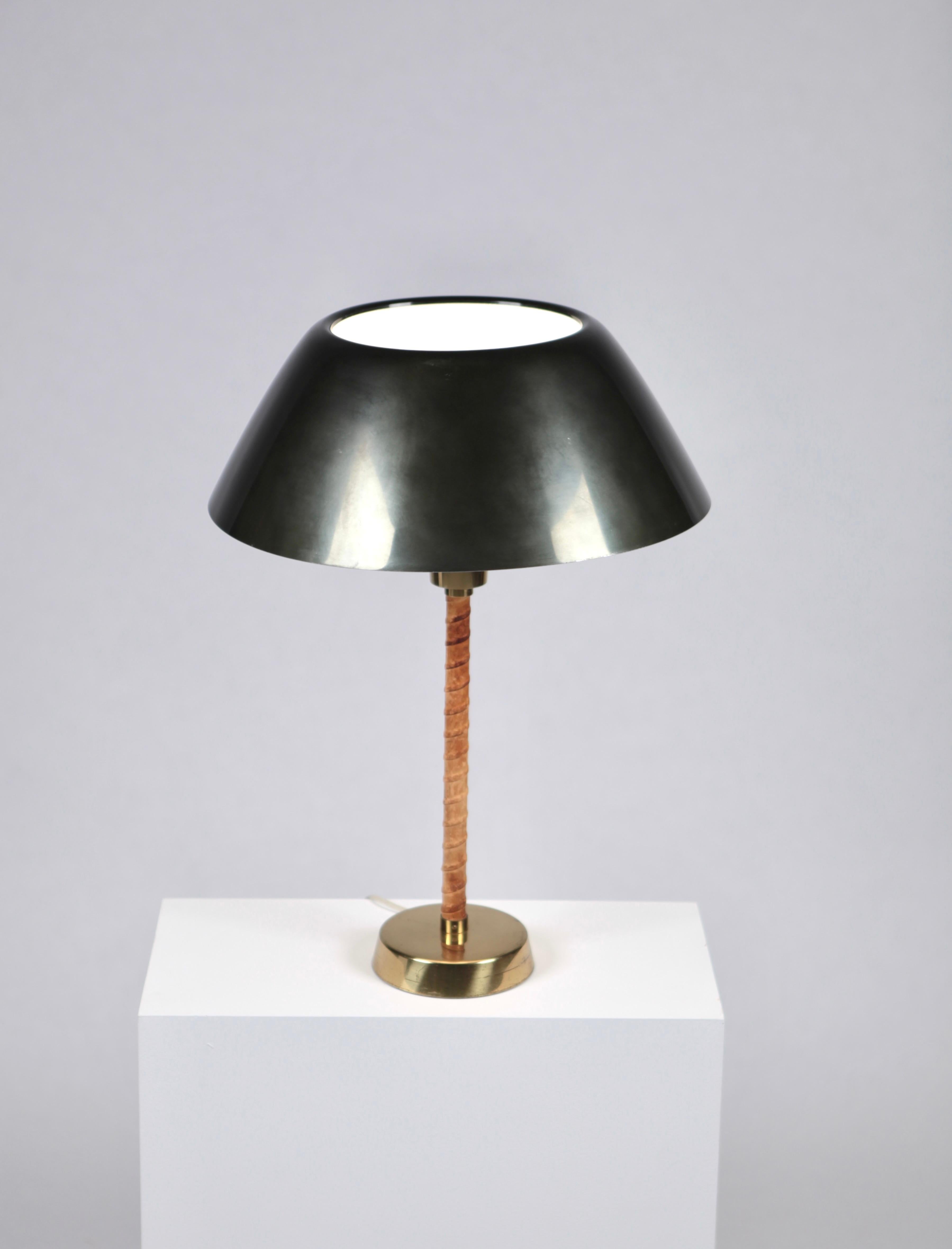 Lisa Johansson-Pape,
Senator table lamp, designed 1947, by Orno in Finland.
Leather, brass and green painted metal shade,
Manufacture mark.