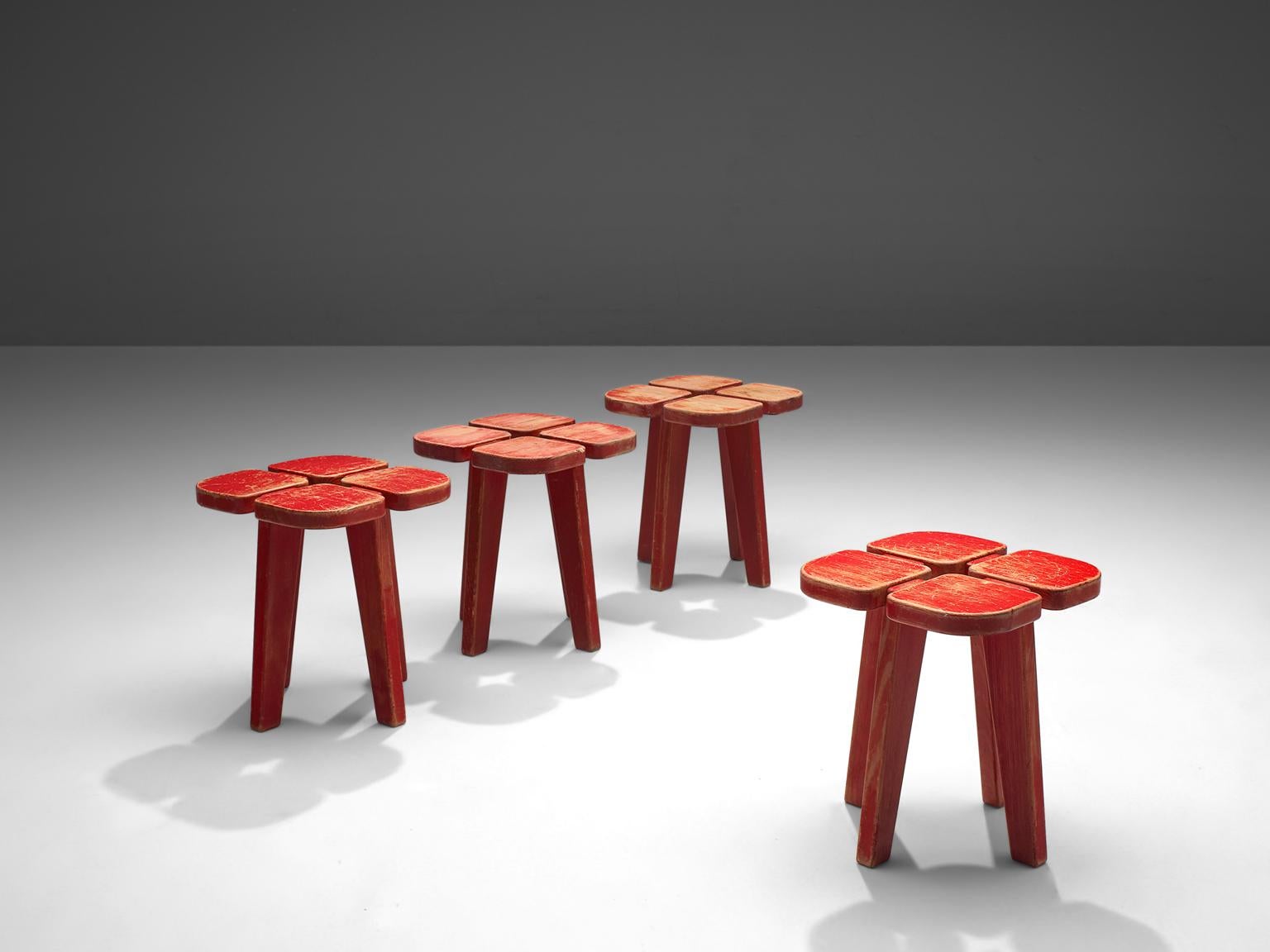 Lisa Johansson-Pape for Stockman Orno, set of 4 red painted 'Apila' barstools, pine, Finland, 1960s. 

Very playful set of 4 stools in red coated pinewood, each with their unique patina. The design is simplistic: A clover top with four sloping legs.