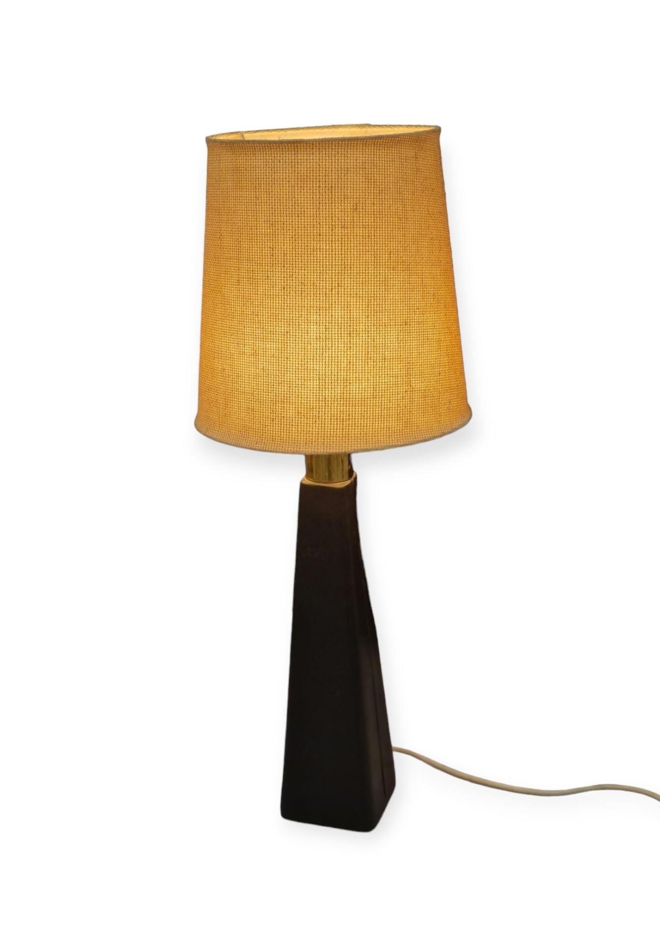 Rare and special Lisa Johansson-Pape table lamp model 46-186 designed for the University of Helsinki. This lamp is much harder to come by than some of the other Pape models and certainly stands out. The lamp consists of a wooden base covered in