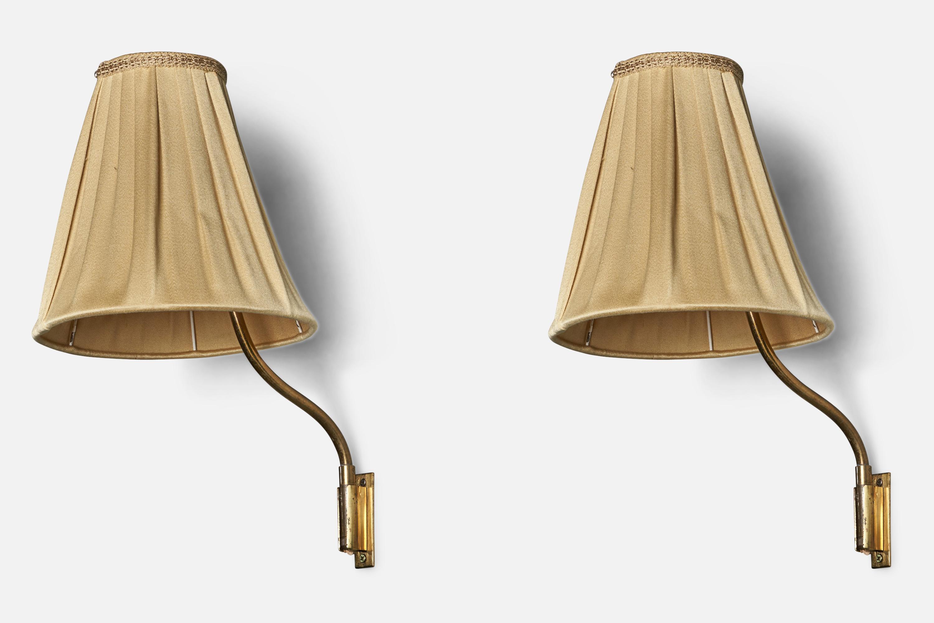 A pair of brass and fabric wall lights, designed by Lisa Johansson-Pape and produced by Ornö, Finland, 1950s.

Note fixtures are plug in with cord feeding from bottom of stem. Not convertible to hard wire.

Overall Dimensions (inches): 15