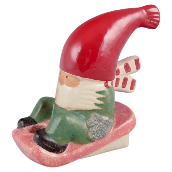 Lisa Larson for Gustavsberg. Ceramic candlestick. Elf on sledge. Late 20th C.