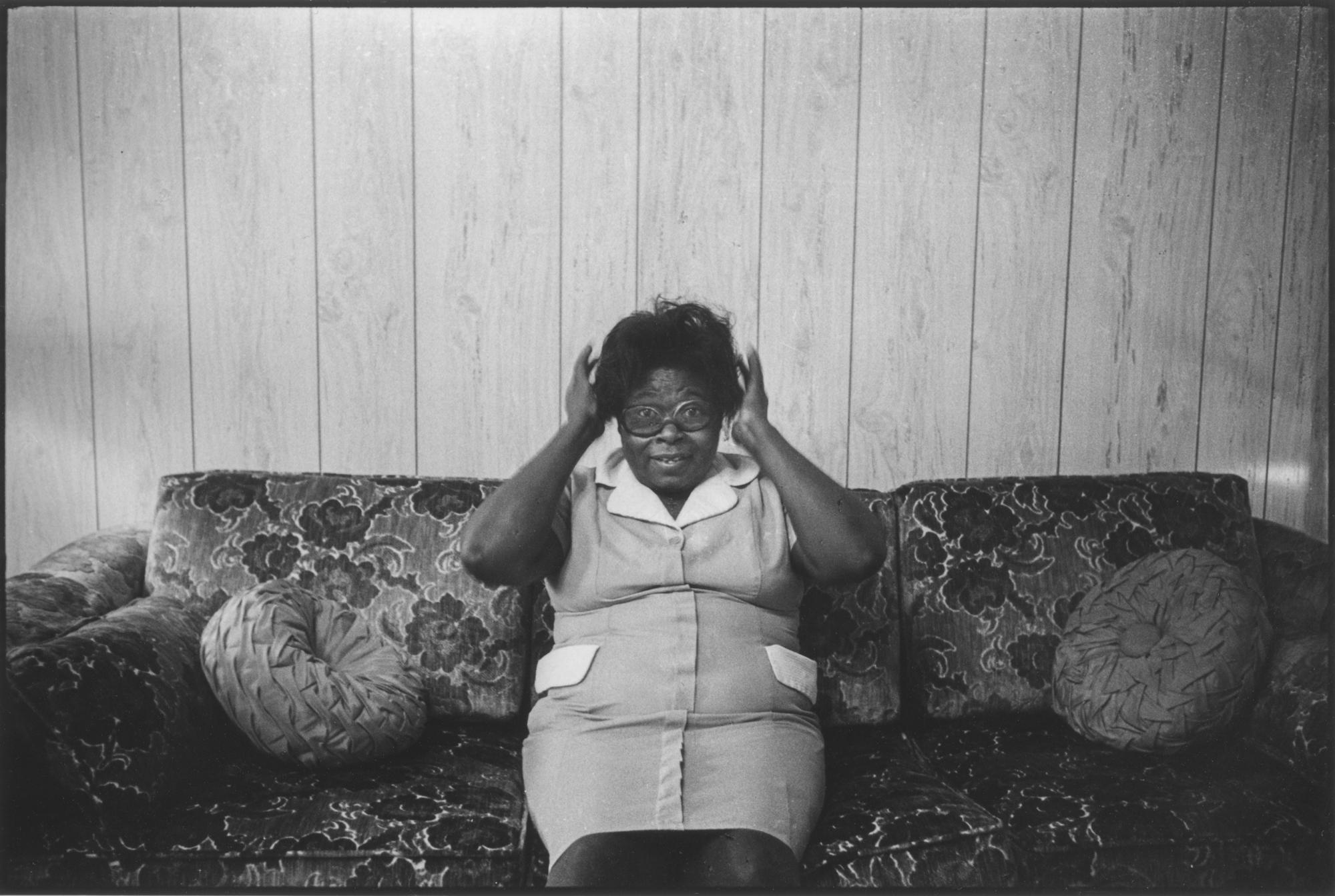 Lisa McCord Black and White Photograph - Cully on Couch, Fixing Hair