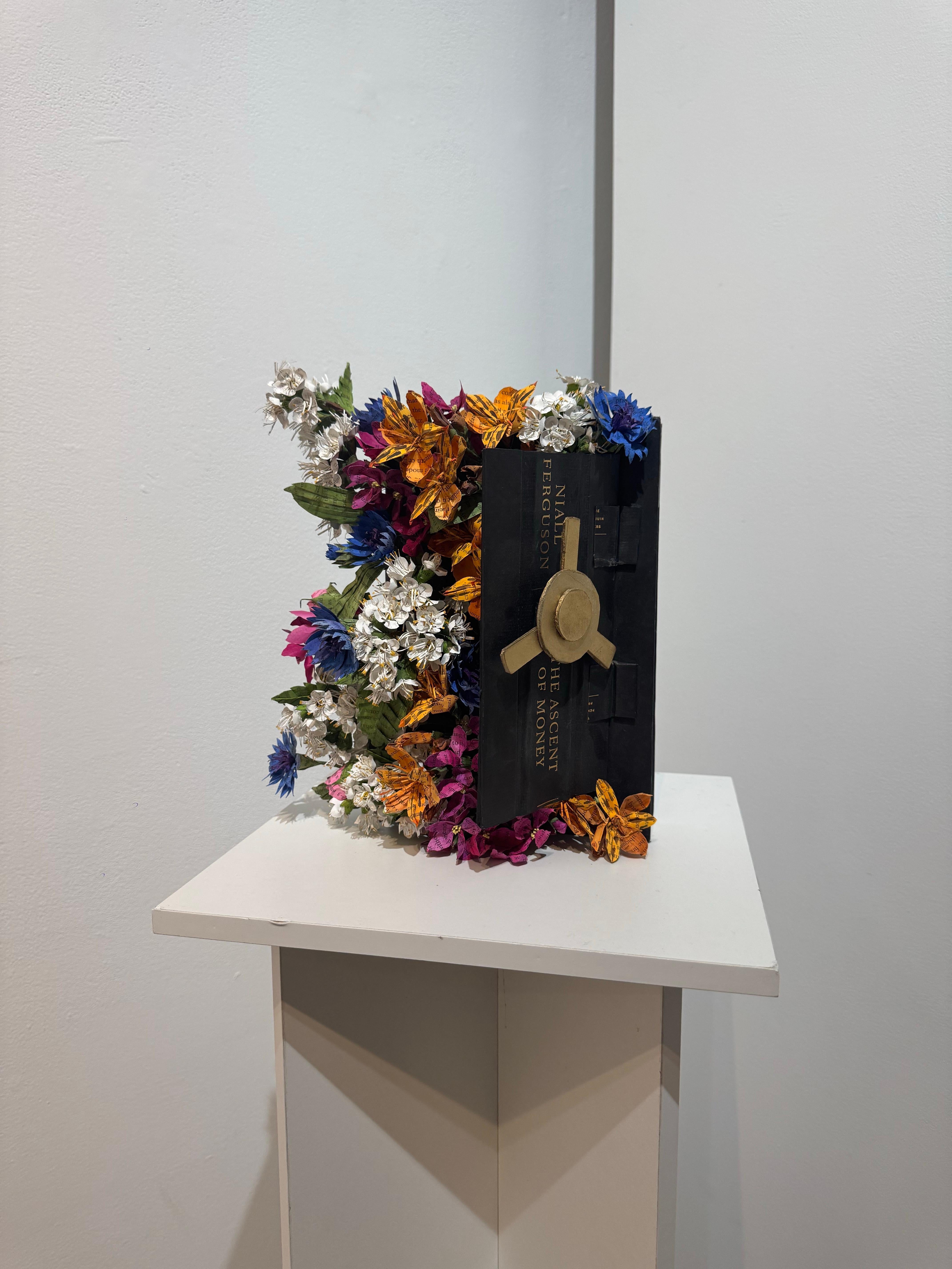 Lisa Meek transforms books by cutting their bindings, painting the pages and folding them to create floral blossoms rooted in the words of the authors. Each page has been lightly tinted adding a dimension of color to the work without obscuring the