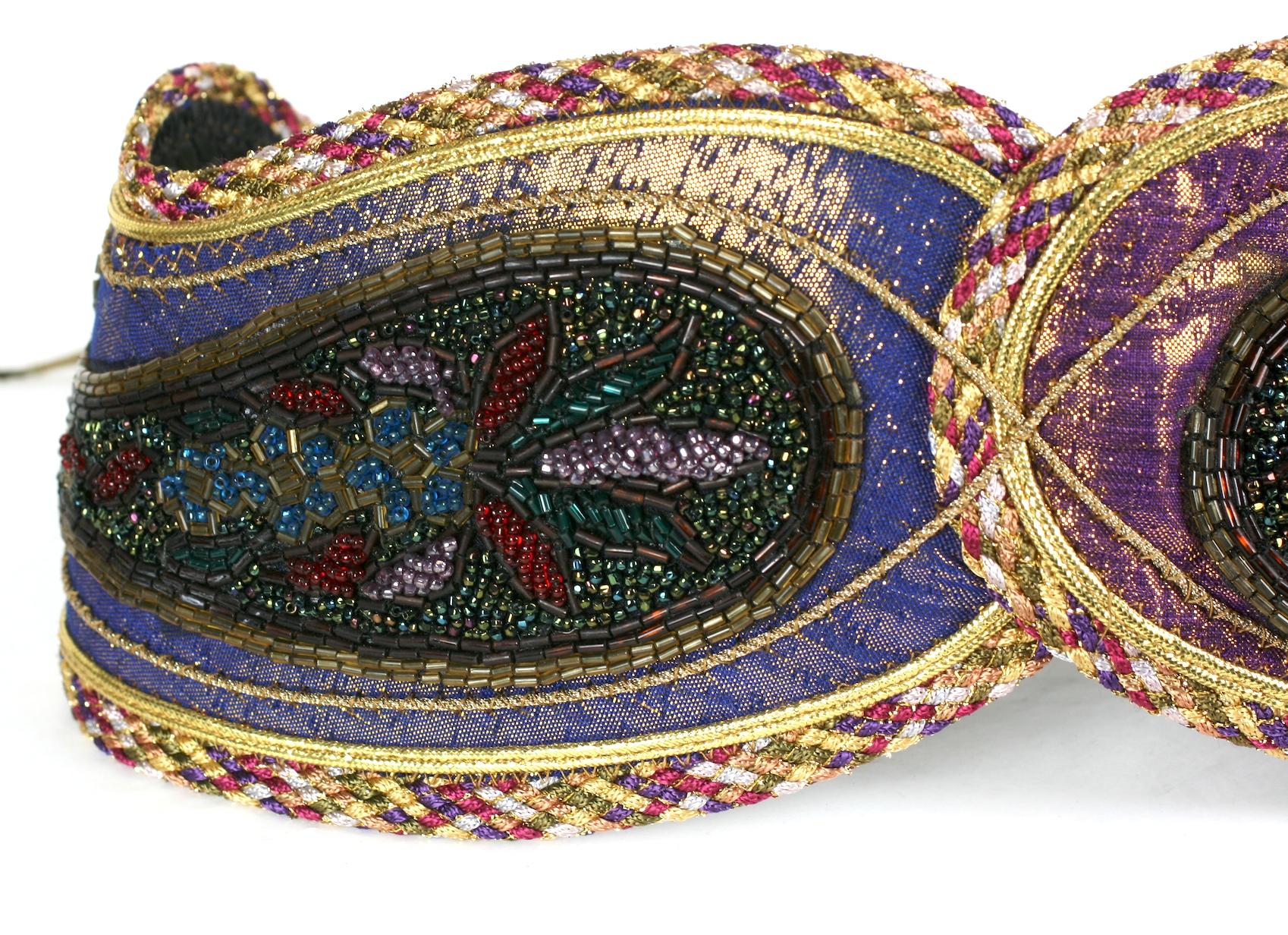 Lisandro Sarasola Extravagant Pieced Belt composed of paisley motifs which are overbeaded with lame cording, lame and applique. Bronze gold leather ties close the belt on the back. Wonderful colorations.
Super striking, would enliven a monochromatic