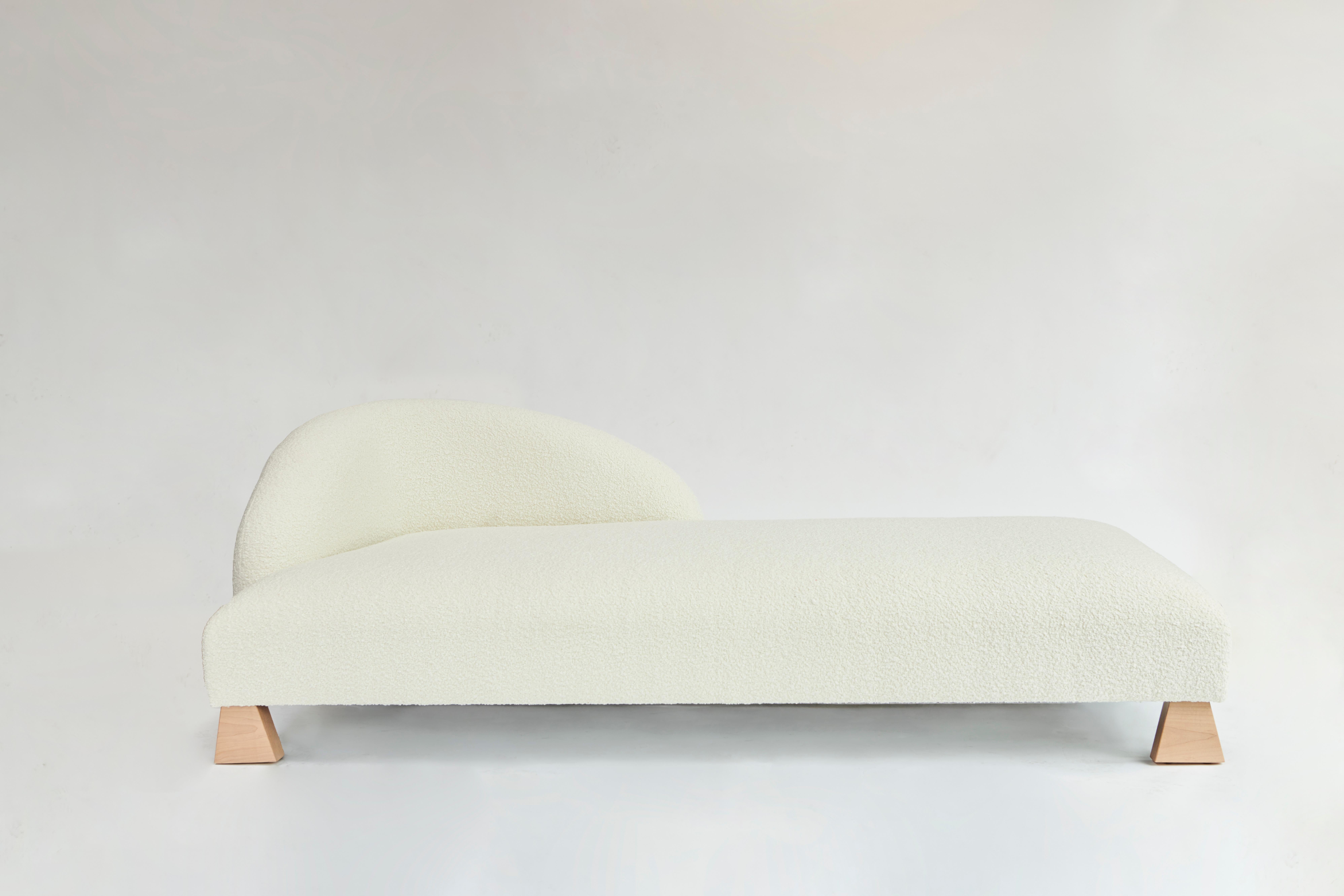 Made to order ivory bouclé chaise designed by Christian Siriano.

Fabric: Ivory Bouclé  (available in custom fabric)
Base: Natural Maple (available in custom finish)

Dimensions:
Overall Width: 80.5”
Overall Depth: 39.5” 
Overall Height: 27”
Seat
