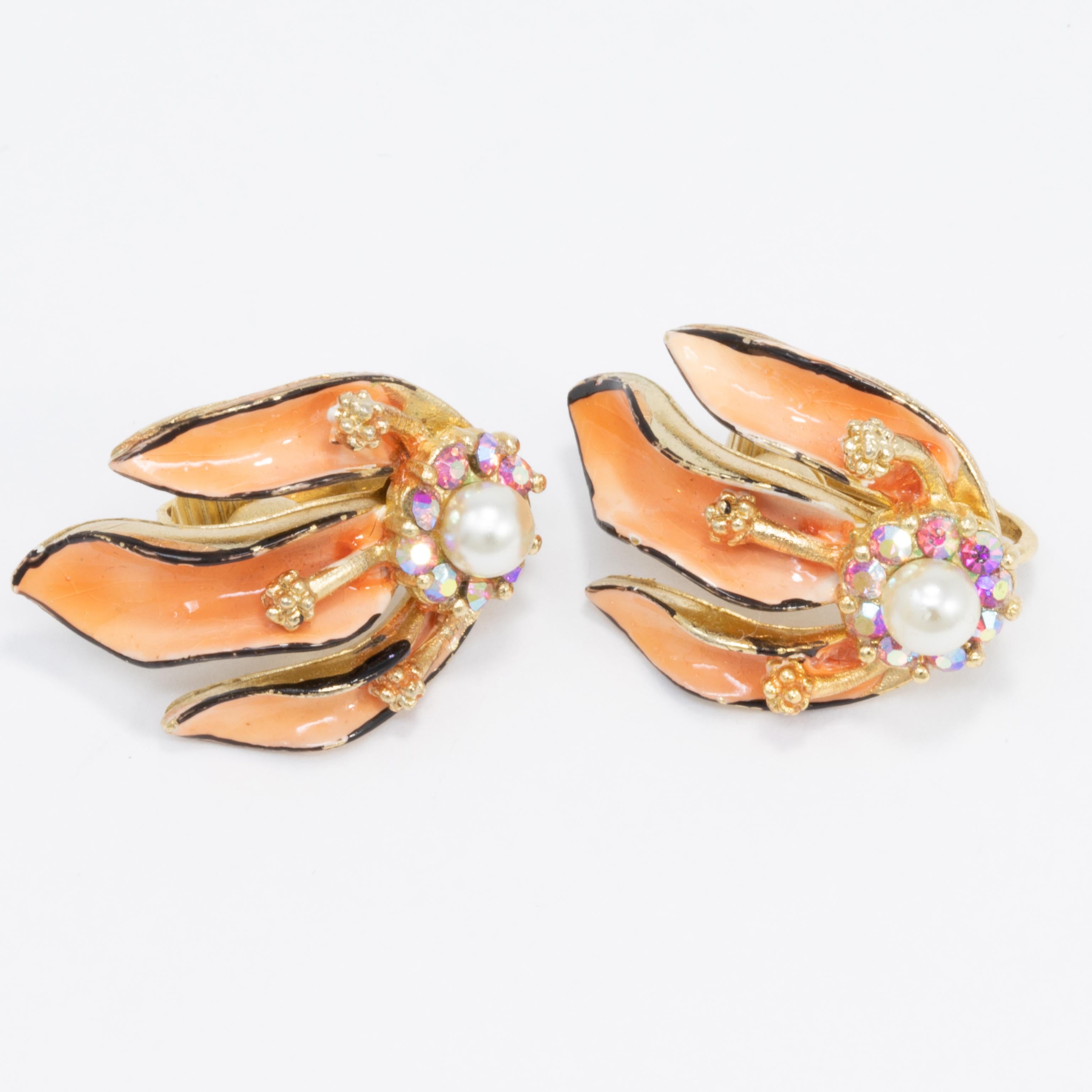 A pair of vintage clip on earrings by Lisner. Features gold-plated floral motifs painted with enamel and decorated with faux pearls & aurora borealis crystals.

Gold-plated.

Hallmarks: Lisner