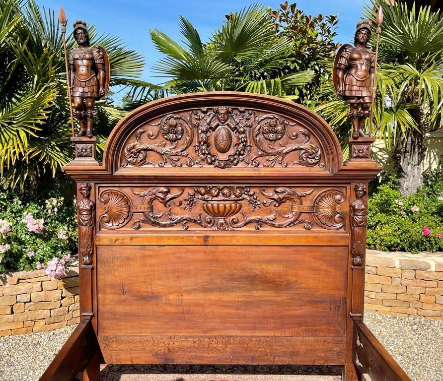 Superb Renaissance-style entirely carved walnut castle bed. This bed features Prometheus, God and Greek hero, stealing the fire with the help of Athena, in order to offer it to humanity. The head and the footboard are quite representative of this